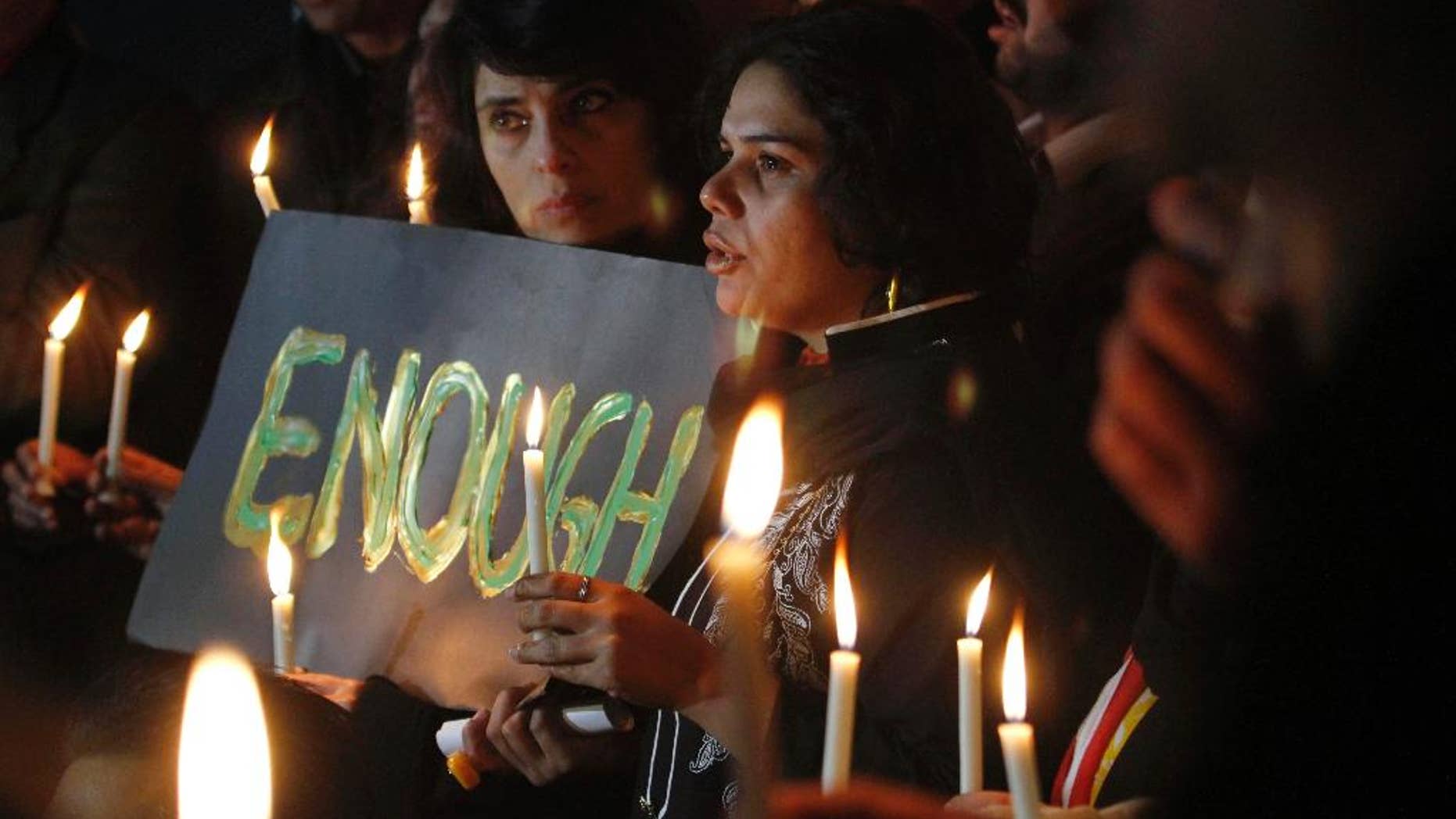 Pakistani civil society members take part in a candle light vigil for the victims of a school attacked by the Taliban in Peshawar, Tuesday, Dec. 16, 2014 in Islamabad, Pakistan. Taliban gunmen stormed a military-run school in the northwestern Pakistani city, killing more than 100 people, officials said, in the worst attack to hit the country in years.(AP Photo/Anjum Naveed)