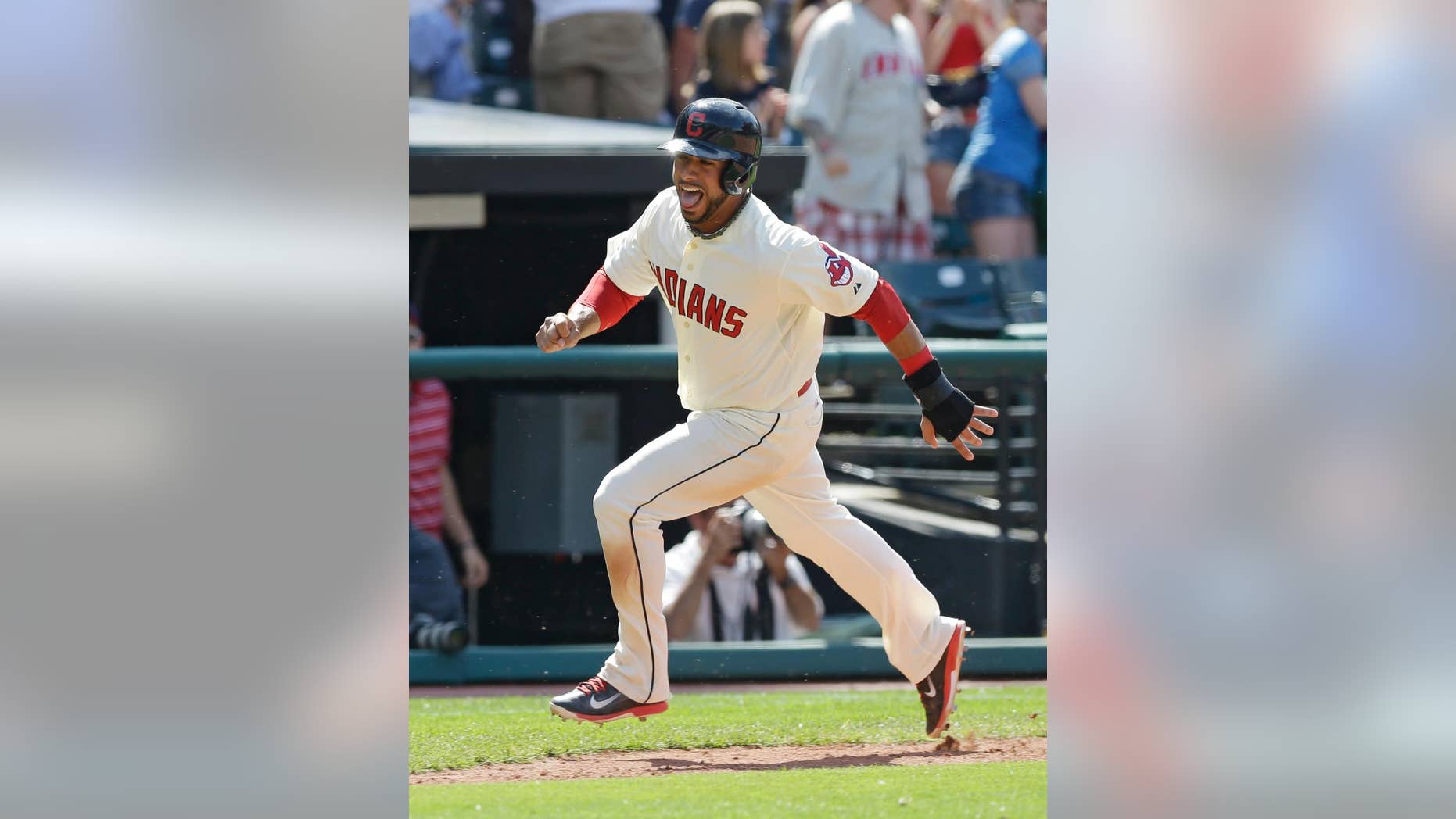 Cleveland Indians' Mike Aviles scores on a game-winning two-run home run hit by Michael Bourn in the ninth inning of a baseball game against the Colorado Rockies, Sunday, June 1, 2014, in Cleveland. The Indians defeated the Rockies 6-4. (AP Photo/Tony Dejak)