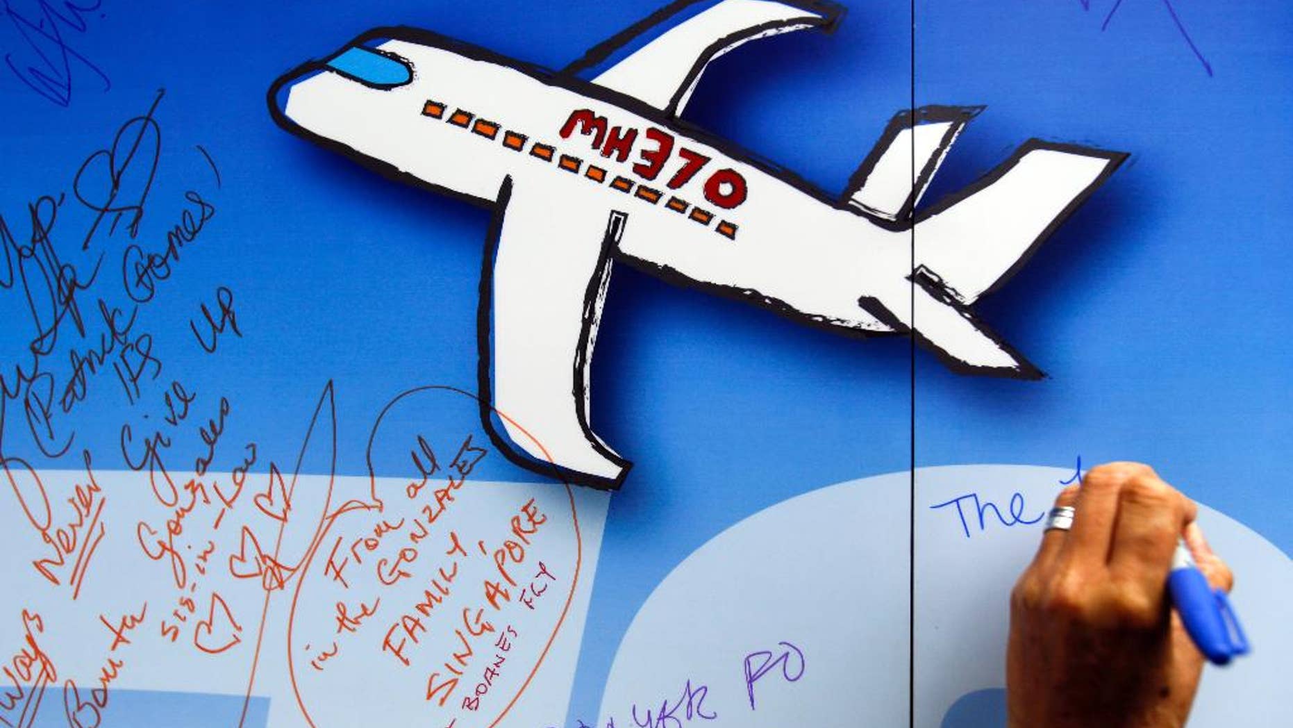 Well wishes are written on a wall of hope during a remembrance event for the ill fated Malaysia Airlines Flight 370 in Kuala Lumpur, Malaysia.