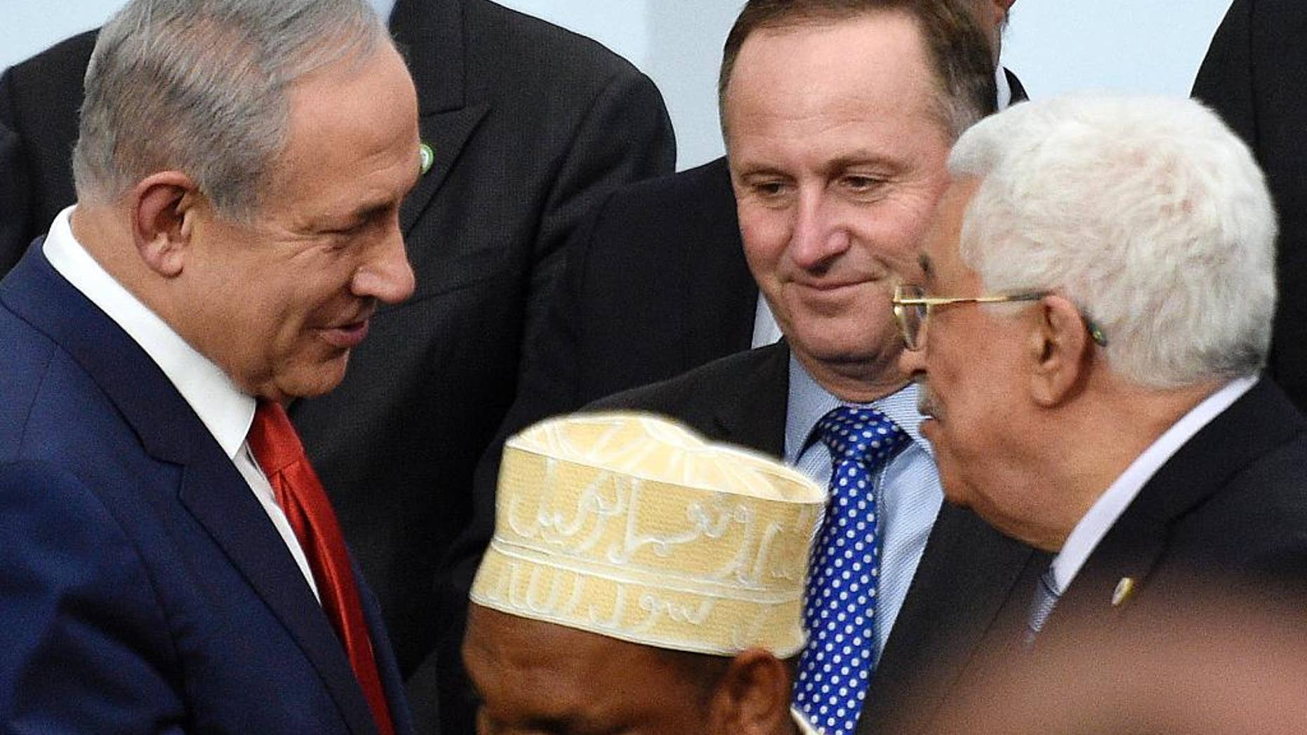 FILE -- In this Nov. 30, 2015 file photo, Israeli Prime Minister Benjamin Netanyahu, left, talks with Palestinian President Mahmoud Abbas, right, at the COP21, the United Nations Climate Change Conference, in Le Bourget, outside Paris, . Russia’s Foreign Ministry says Israeli and Palestinian leaders have agreed “in principle” to meet in Moscow for talks. The ministry’s spokeswoman Maria Zakharova said on Thursday, Sept. 8, 2016, that Moscow has heard from the offices of Abbas and Netanyahu that he two are confirming they agreed to meet in Moscow, though it’s not clear when that will happen. No date has been set. (Martin Bureau/Pool Photo via AP, File)