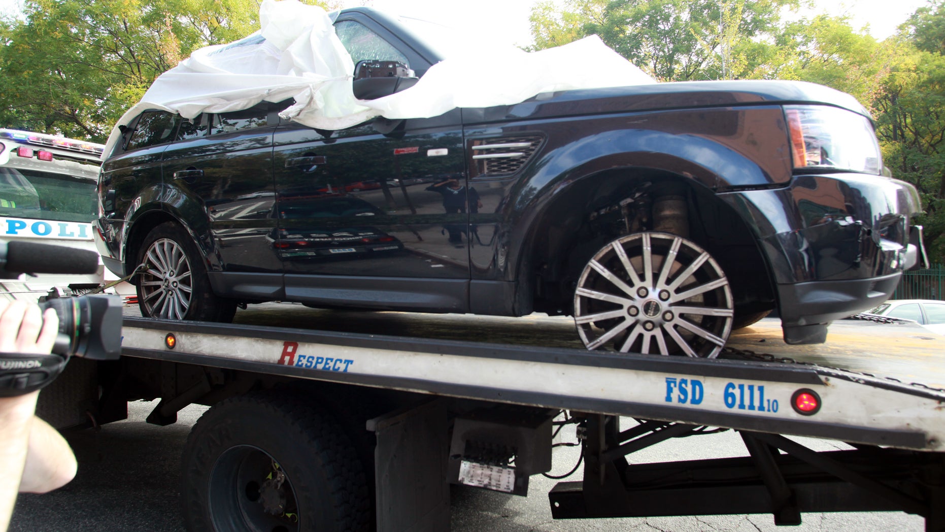 The Range Rover involved in the bikers attack is being moved from the police precinct for further police investigation Saturday, Oct. 5, 2013 in New York. Last weekend, dozens of bikers stopped the Range Rover SUV on a highway, attacked the vehicle, then chased the driver and pulled him from the car after he plowed over a motorcyclist while trying to escape, police said. The driver, Alexian Lien, needed stitches after being pummeled by the bikers. The motorcyclist who was crushed by the SUV, Edwin Mieses Jr., of Lawrence, Massachusetts, suffered a broken spine and two broken legs and may never walk again, his family said. Robert Sims, 35, of Brooklyn, was arrested on charges of gang assault and weapons possession. Police said he took part in the attack on Lien (AP Photo/David Karp)