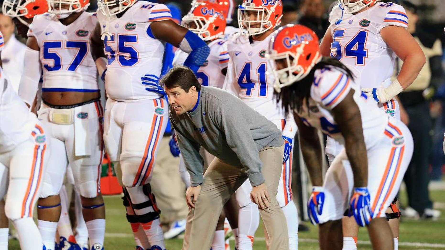 Florida coach Will Muschamp watches his players warm up for an NCAA college football game against Vanderbilt on Saturday, Nov. 8, 2014, in Nashville, Tenn. (AP Photo/Mark Humphrey)