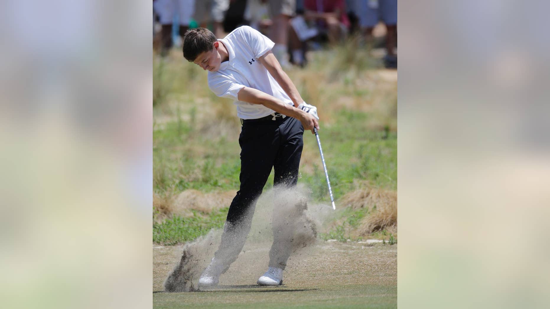 Amateur, Matthew Fitzpatrick, England, hits from the fairway on the 18th hole during the final round of the U.S. Open golf tournament in Pinehurst, N.C., Sunday, June 15, 2014. (AP Photo/Eric Gay)