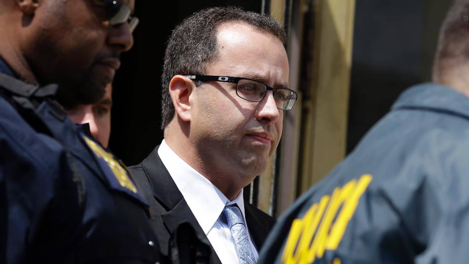 Former Subway pitchman Jared Fogle leaves the Federal Courthouse in Indianapolis, Wednesday, Aug. 19, 2015 following a hearing on child-pornography charges. Fogle agreed to plead guilty to allegations that he paid for sex acts with minors and received child pornography in a case that destroyed his career at the sandwich-shop chain and could send him to prison for more than a decade. (AP Photo/Michael Conroy)