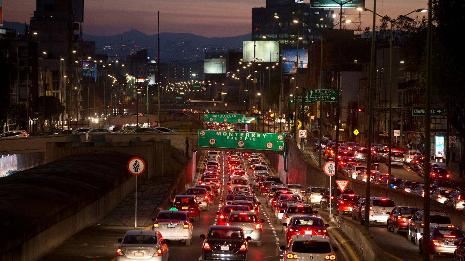FILE - In this March 30, 2016 file photo, cars sit in evening rush hour traffic in Mexico City. Mexican authorities issued a new smog alert Saturday, May 14, 2016, for the capital after ozone levels rose above 150 percent of acceptable limits. On Sunday 20 percent of vehicles will be barred from the streets of the capital and the surrounding suburbs. If conditions don’t improve, that will increase to 40 percent on Monday. (AP Photo/Rebecca Blackwell, File)