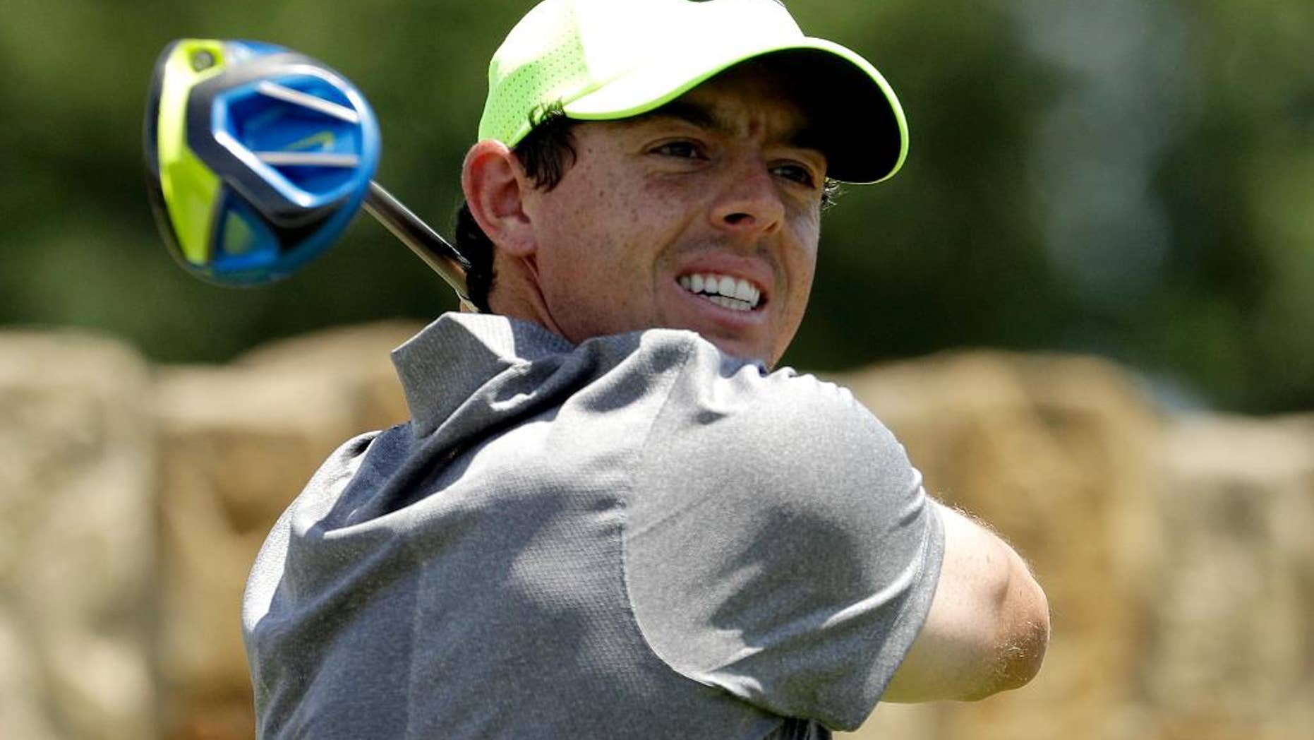 Rory McIlroy, of Northern Ireland, watches his tee shot on the ninth hole during the rain delayed second round of the U.S. Open golf championship at Oakmont Country Club on Saturday, June 18, 2016, in Oakmont, Pa. (AP Photo/Charlie Riedel)