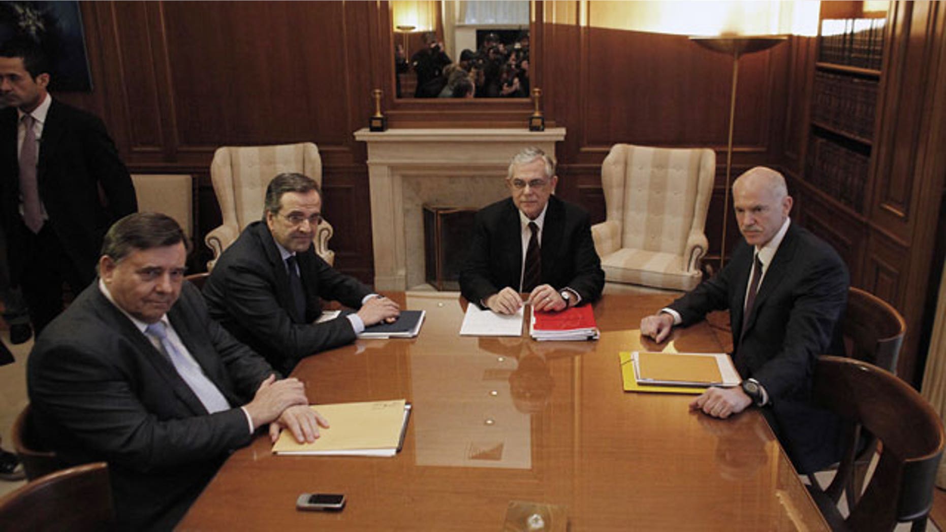 Feb. 4, 2012: The leaders of the three parties backing Greece's coalition government, George Papandreou, right, Giorgos Karatzaferis, left, and Antonis Samaras, 2nd left, meet with Prime Minister Lucas Papademos, 2nd from left, in Athens.