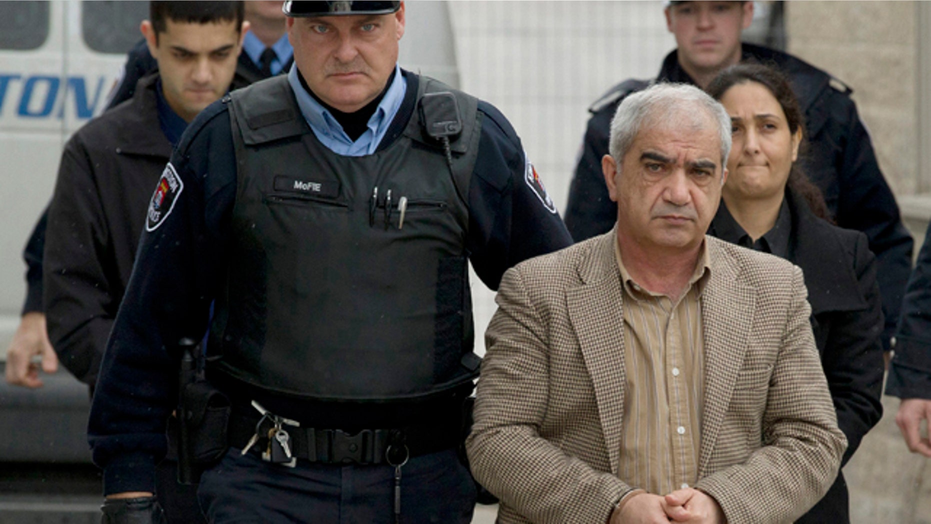 Jan. 25, 2012: Tooba Yahya, right, Mohammad Shafia, front, and their son Hamed Mohammed Shafia, back left, are escorted into the Frontenac County courthouse in Kingston, Ontario, Canada.