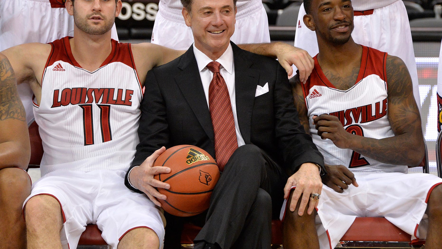 Louisville's Luke Hancock, left, head coach Rick Pitino, center, and Russ Smith pose for the cameras during NCAA college basketball media day, Saturday, Oct. 12, 2013, in Louisville, Ky. (AP Photo/Timothy D. Easley)