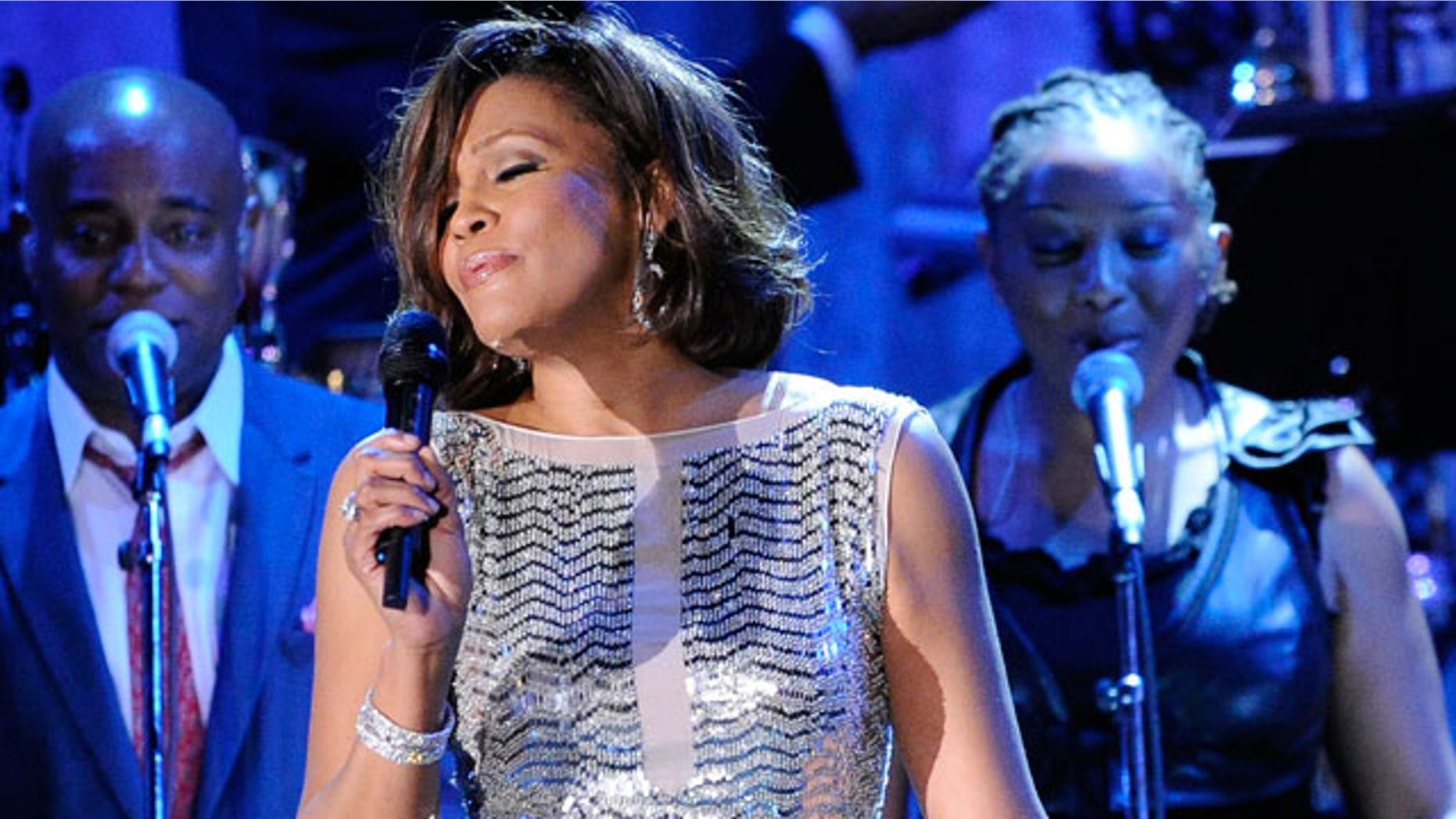In this Feb. 13, 2011 file photo, singer Whitney Houston performs at the pre-Grammy gala & salute to industry icons with Clive Davis honoring David Geffen in Beverly Hills, Calif. The singer's rep confirms she just entered rehab. (AP)