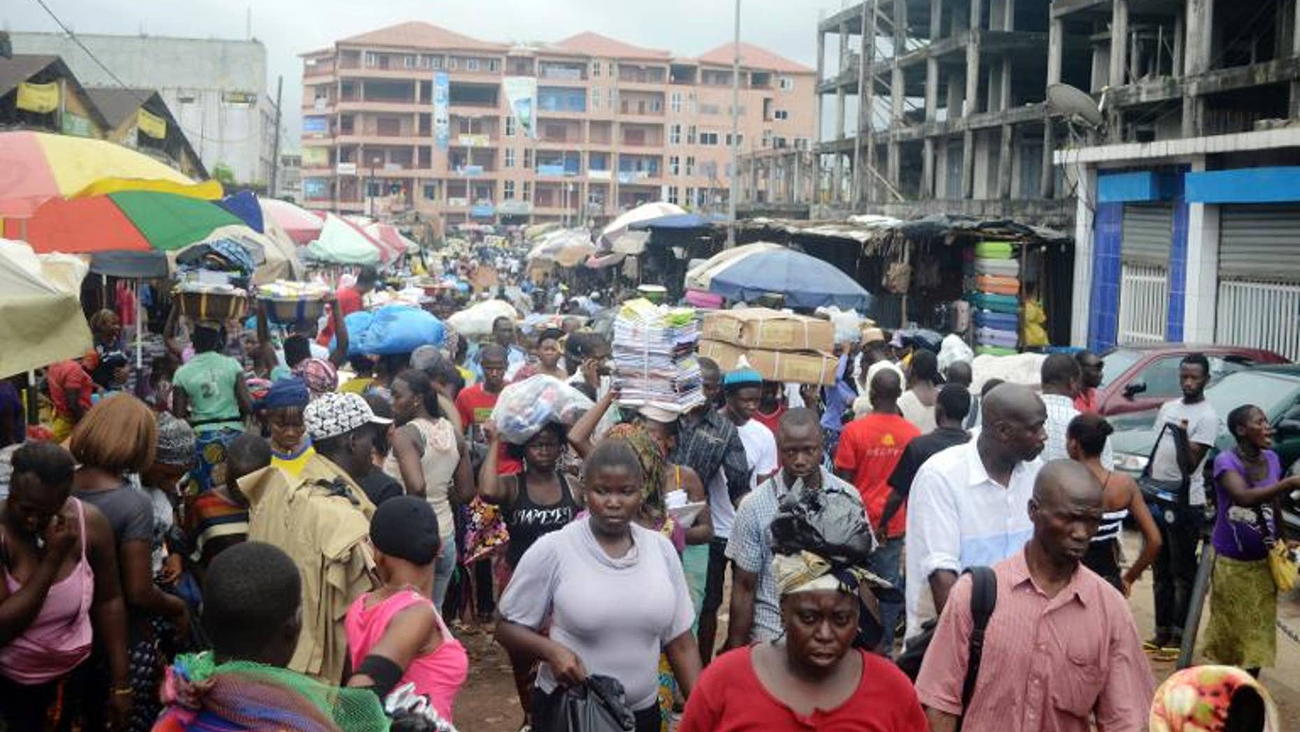 People walking in Conakry street, Guinea, September 24, 2013
