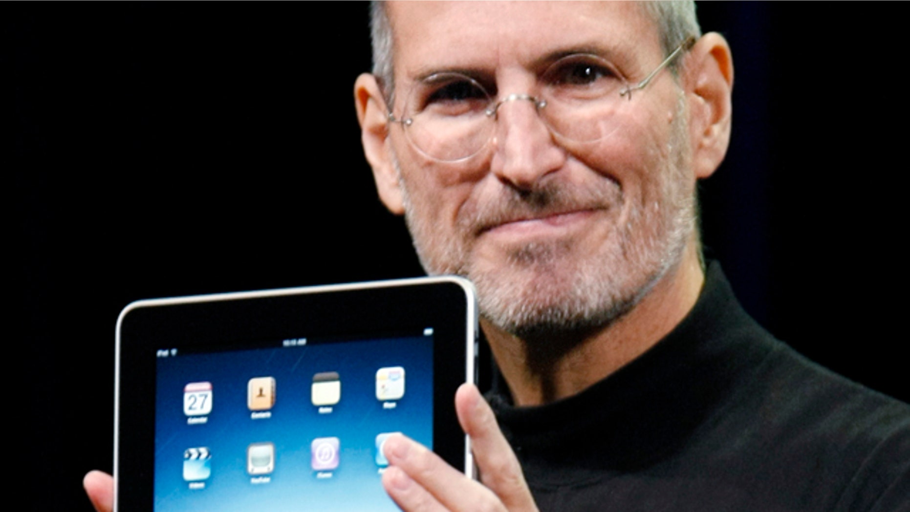 Jan. 27, 2010: Apple CEO Steve Jobs holds the new iPad during a product announcement in San Francisco.