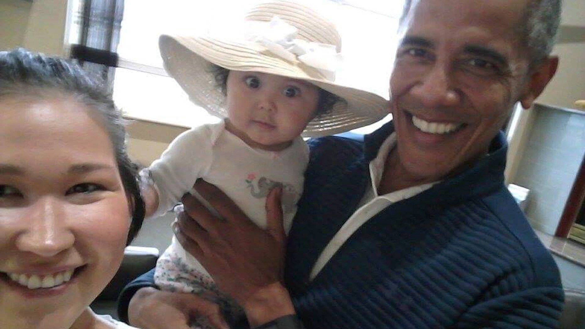 July 3: .S. President Barack Obama holds Jackinsky's 6-month-old baby girl while posing for a selfie with the pair at a waiting area at Anchorage International Airport, in Anchorage, Alaska. Jackinsky said Obama walked up to her and asked, "Who is this pretty girl?"