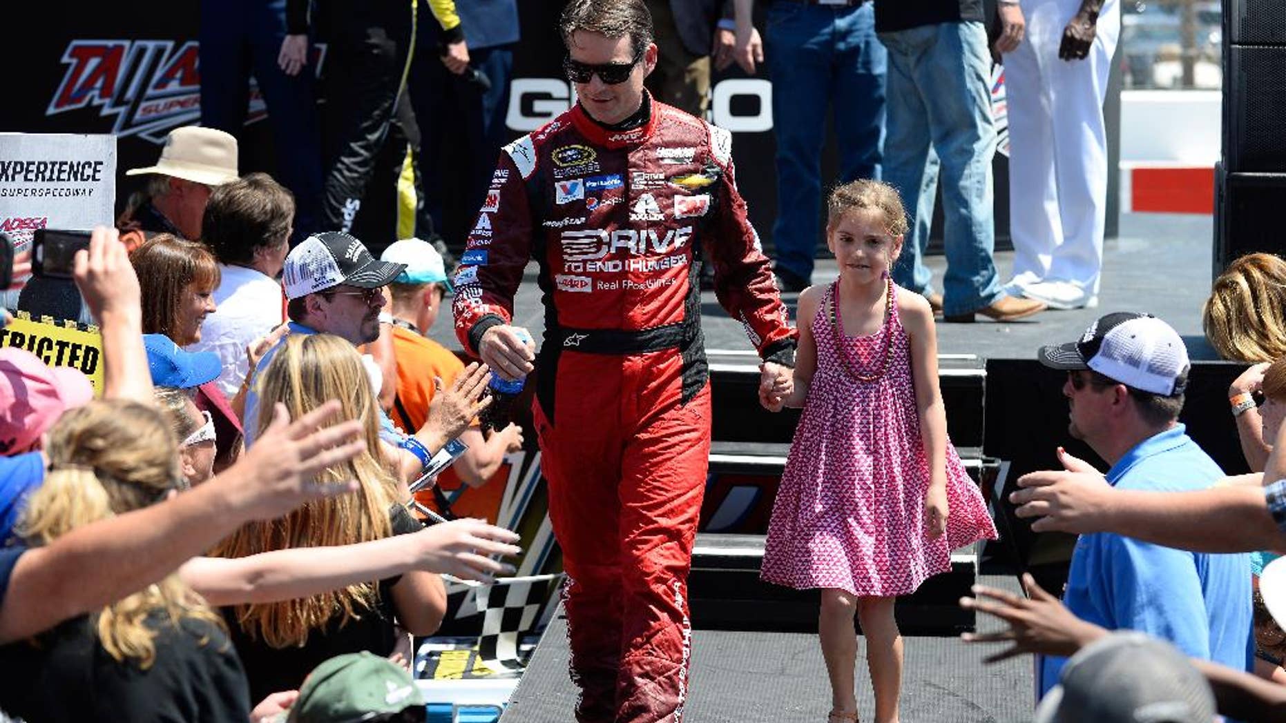 Pole winner Jeff Gordon, left, walks with his daughter Ella Sofia during introductions for the Talladega 500 NASCAR Sprint Cup Series auto race at Talladega Superspeedway, Sunday, May 3, 2015, in Talladega, Ala. (AP Photo/David Tulis)