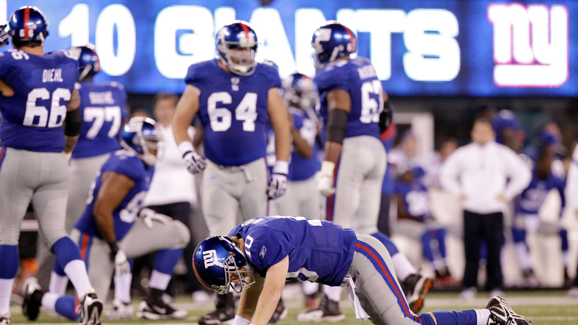 New York Giants quarterback Eli Manning (10) reacts after being sacked by Philadelphia Eagles defensive end Jason Babin and fumbling the ball during the fourth quarter of an NFL football game, Sunday, Nov. 20, 2011 in East Rutherford, N.J. The Giants lost the game 17-10. (AP Photo/Kathy Willens)
