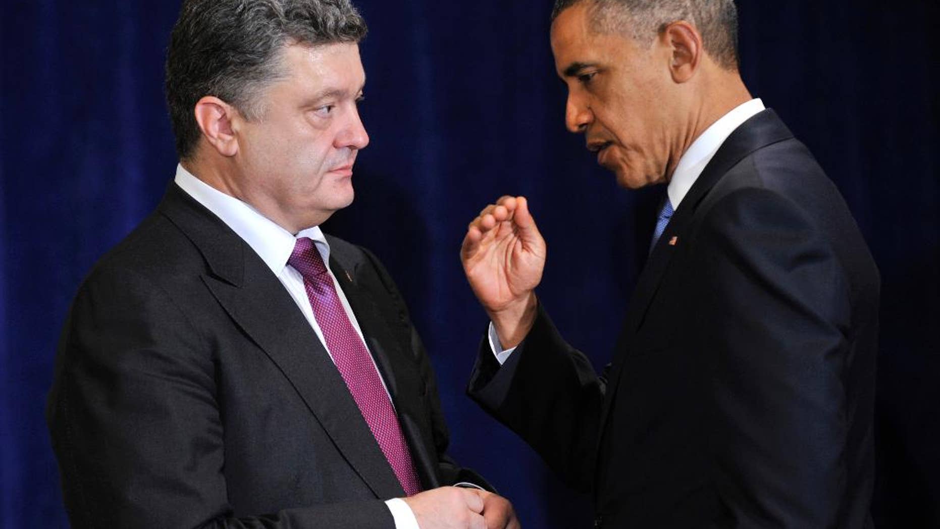 U.S. President Barack Obama, right, meets with Ukraine president-elect Petro Poroshenko in Warsaw, Poland, Wednesday, June 4, 2014. President Barack Obama says Ukraine can be a vibrant, thriving democracy if the United States and the international community stand behind it. (AP Photo/ Mykola Lazarenko, Pool)