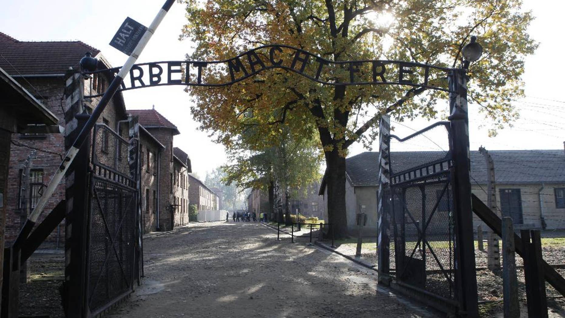 File - In this Oct. 19, 2012 file photo the entrance with the inscription "Arbeit Macht Frei" (Work Sets You Free) gate of the former German Nazi death camp of Auschwitz is seen at the Auschwitz-Birkenau memorial in Oswiecim, Poland. A group of nearly a dozen people took off their clothes, killed a sheep and chained themselves together by the gate before being detained by police, Friday, March 24, 2017. (AP Photo/Czarek Sokolowski,file)