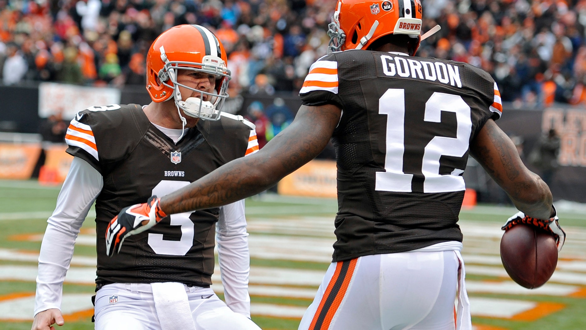 Cleveland Browns quarterback Brandon Weeden (3) celebrates with wide receiver Josh Gordon (12) after they connected on a 21-yard touchdown pass against the Jacksonville Jaguars in the second quarter of an NFL football game on Sunday, Dec. 1, 2013, in Cleveland. (AP Photo/David Richard)