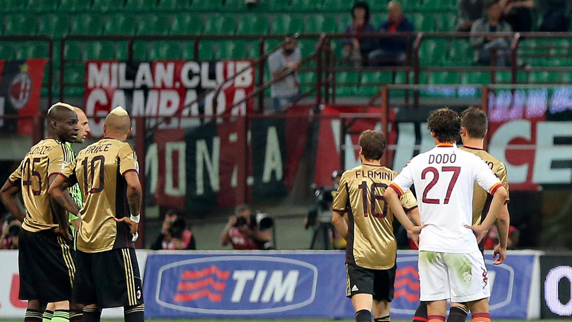 FILE - In this May 12, 2013, file photo AC Milan players Mario Balotelli, left, Kevin Prince Boateng (10) stand on the pitch during a stoppage in play in a Serie A soccer match between AC Milan and AS Roma, at Milan's San Siro Stadium. The game was stopped for almost two minutes because of racial abuse by Roma fans towards Balotelli and Boateng. (AP Photo/Antonio Calanni, File)