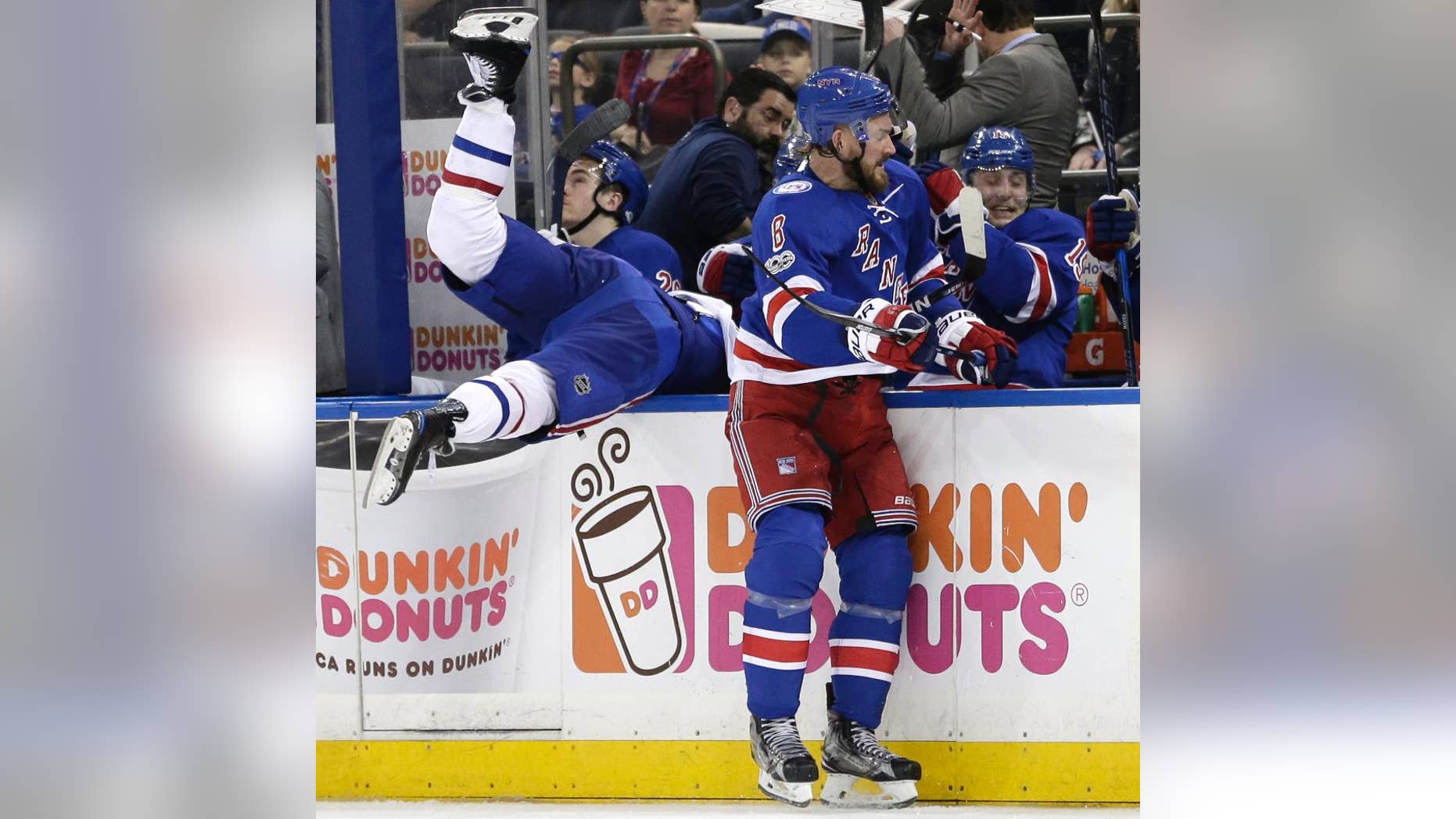 New York Rangers' Kevin Klein, right, checks Montreal Canadiens' Torrey Mitchell over the boards during the third period in Game 3 of an NHL hockey first-round playoff series, Sunday, April 16, 2017, in New York. The Canadiens defeated the Rangers 3-1. (AP Photo/Seth Wenig)