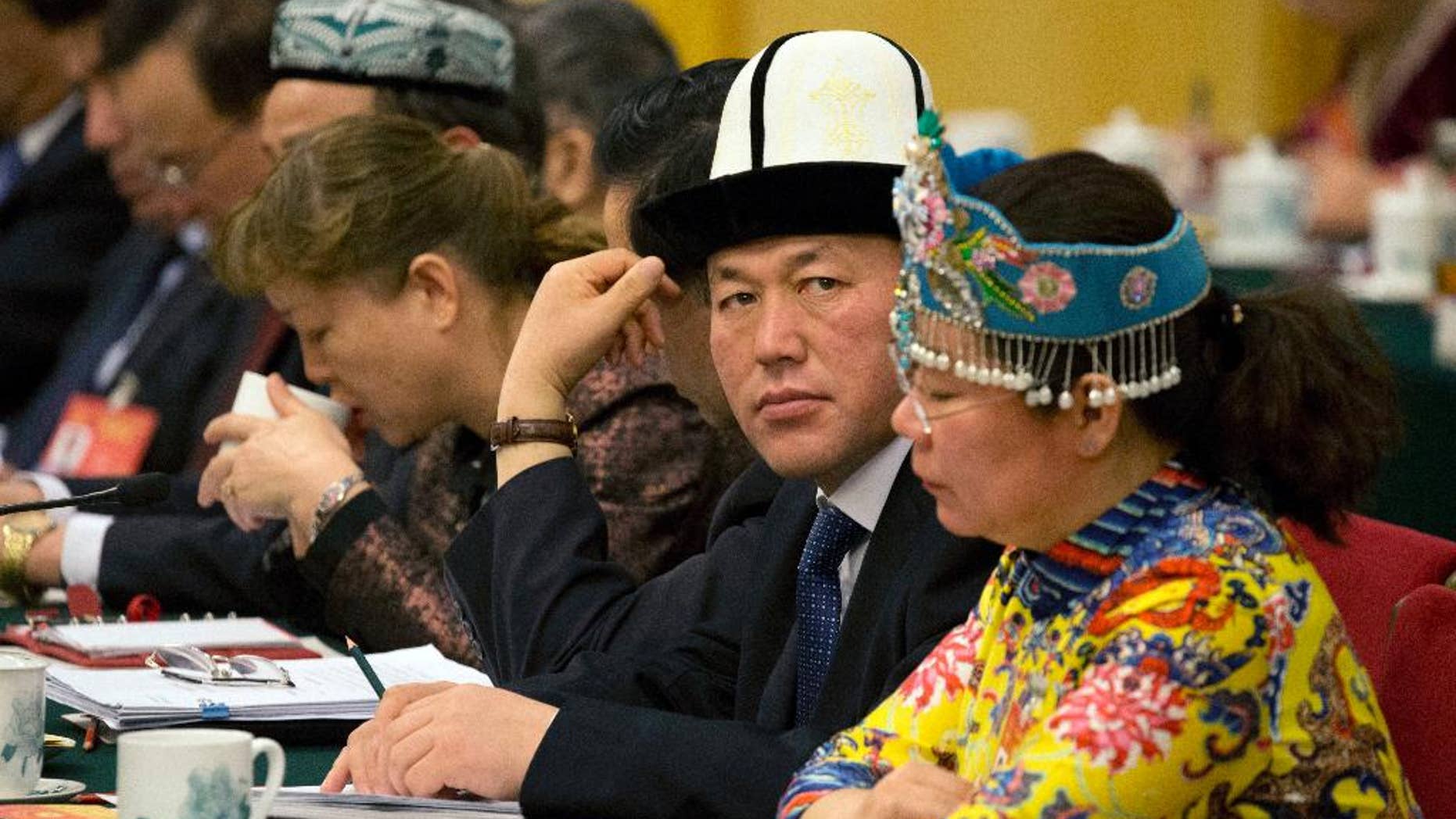 Delegates from Xinjiang meet in the Xinjiang Hall of the Great Hall of the People on the sideline of the National People's Congress in Beijing, China, Sunday, March 12, 2017. China's ruling Communist Party is hardening its rhetoric about Islam, with top officials making repeated warnings this past week about the specter of global religious extremism seeping into the country. (AP Photo/Ng Han Guan)