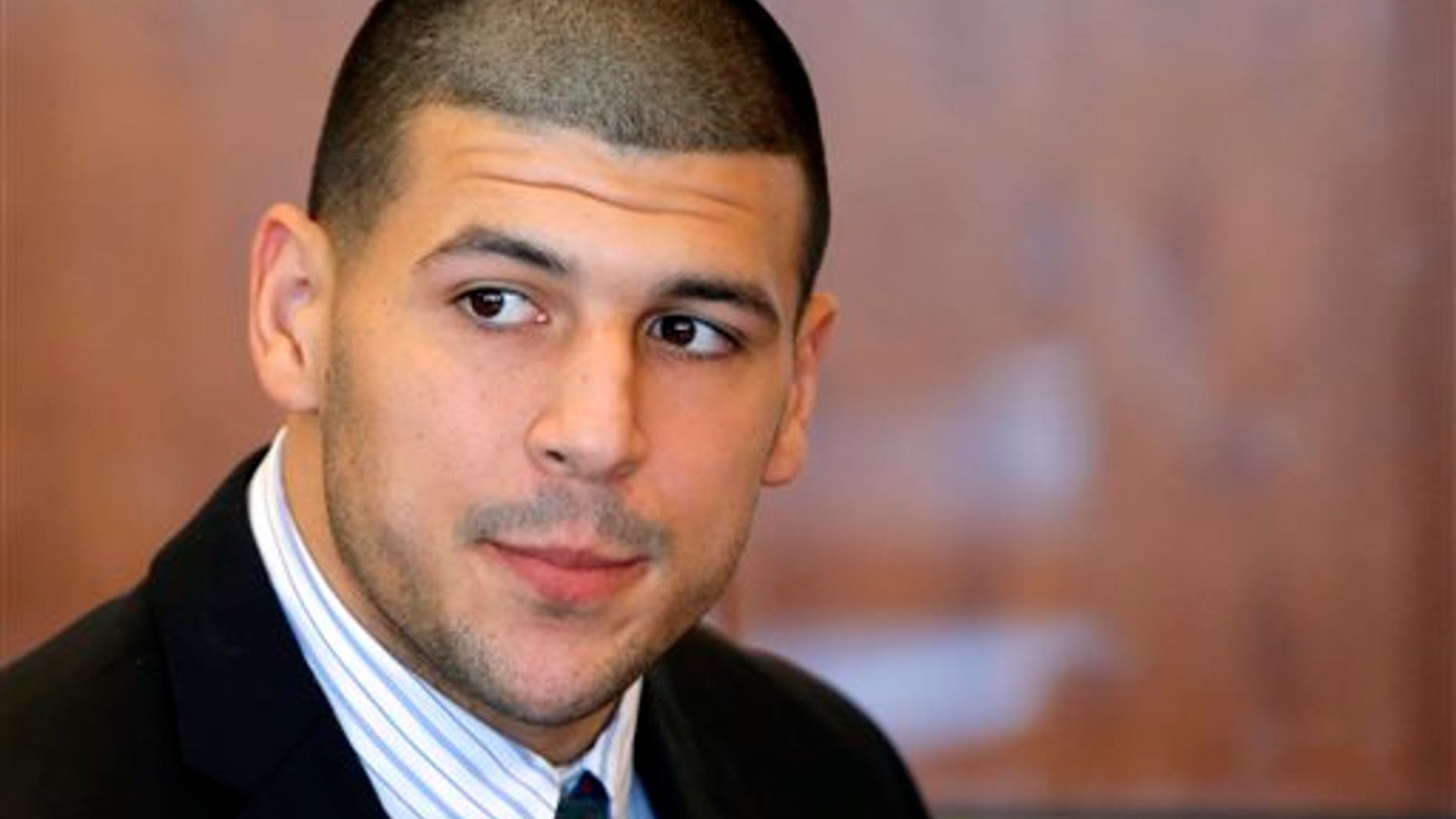 FILE - In this Oct. 9, 2013 file photo, former New England Patriots NFL football player Aaron Hernandez attends a pretrial court hearing in Fall River, Mass. Hernandez has pleaded not guilty in the killing of 27-year-old Odin Lloyd, a semi-professional football player from Boston who was dating the sister of Hernandez's girlfriend. On Monday, Dec. 16, 2013, Lloyd's family filed a wrongful death suit against Hernandez in court in New Bedford, Mass. (AP Photo/Brian Snyder, Pool, File)