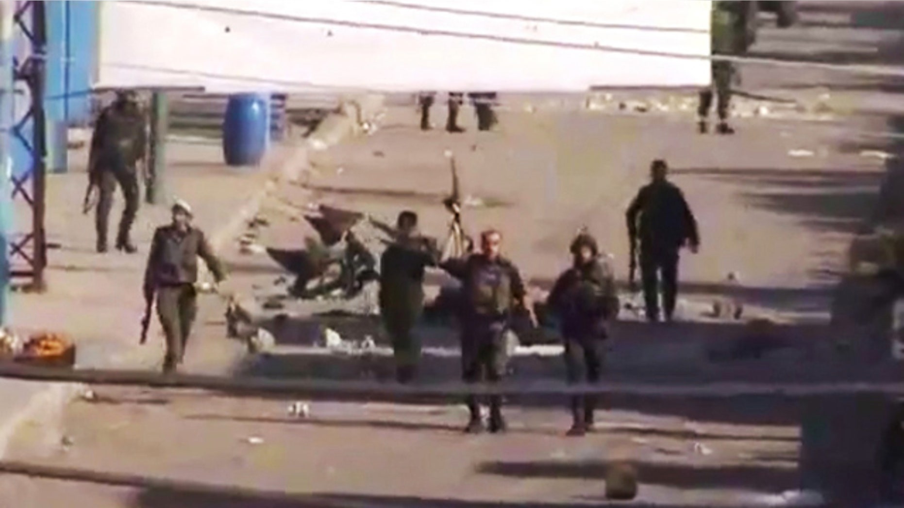 DEC. 19: In this image from TV shown on the internet made available by the Sham News Network, is believed to be soldiers walking down the street in Daraa, Syria.