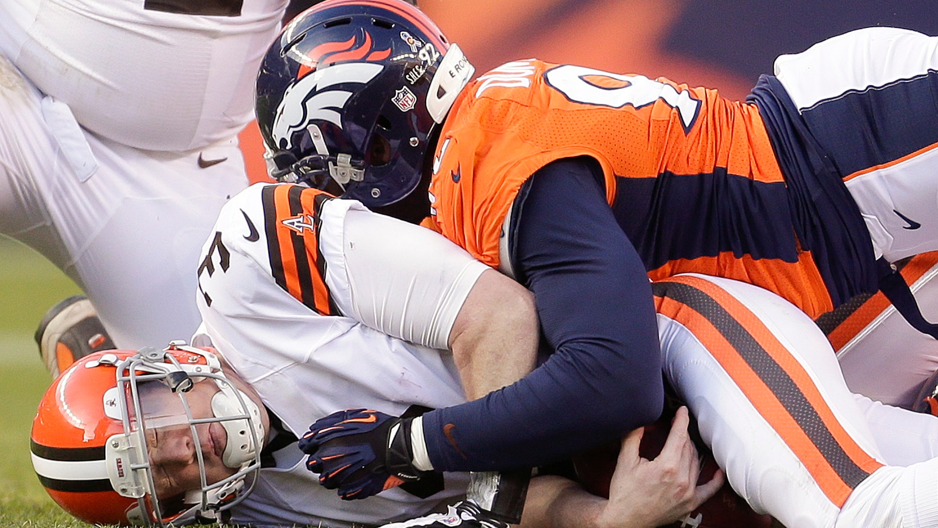 Cleveland Browns quarterback Brandon Weeden (3) is sacked by Denver Broncos defensive end Elvis Dumervil (92) in the third quarter of an NFL football game, Sunday, Dec. 23, 2012, in Denver. (AP Photo/Joe Mahoney)
