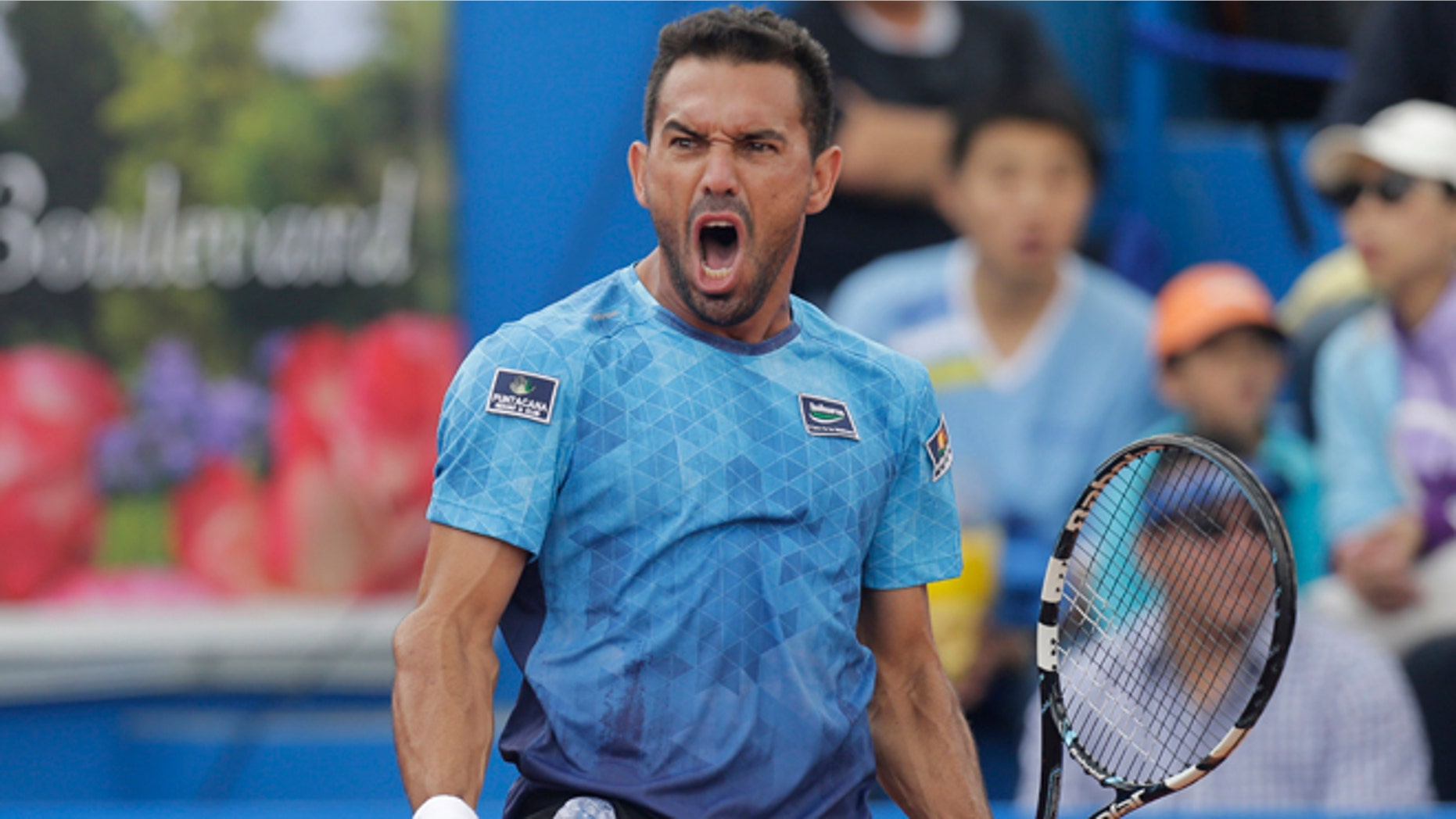 Victor Estrella from the Dominican Republic celebrates a winning a point against Spain's Feliciano Lopez in the final match of the ATP World Tour Ecuador Open Quito tournament, in Quito, Ecuador, Sunday, Feb. 8, 2015. Estrella became the oldest first-time winner of an ATP event in the Open Era, beating top-seeded Lopez. The 34-year-old Dominican won 6-2, 6-7 (5), 7-6 (5) in his first ATP final. He was the first Dominican to reach a top-level ATP final. (AP Photo/Dolores Ochoa)