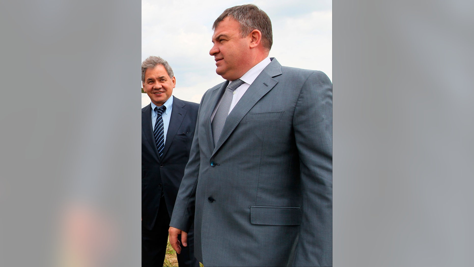 FILE - This Tuesday, June 26, 2012 file photo shows then Defense Minister Anatoly Serdyukov, right, and then Moscow region governor Sergei Shoigu are photographed together at the village of Petrovskopye, Moscow region. Russia’s main investigative agency has filed charges against Serdyukov Thursday, Nov. 28, 2013, accusing him of using servicemen and government funds to build a road to a vacation home and do landscaping work on the property. If convicted, Serdyukov could face up to five years in prison. (AP Photo/RIA Novosti, Yekaterina Shtukina, Government Press service, File)