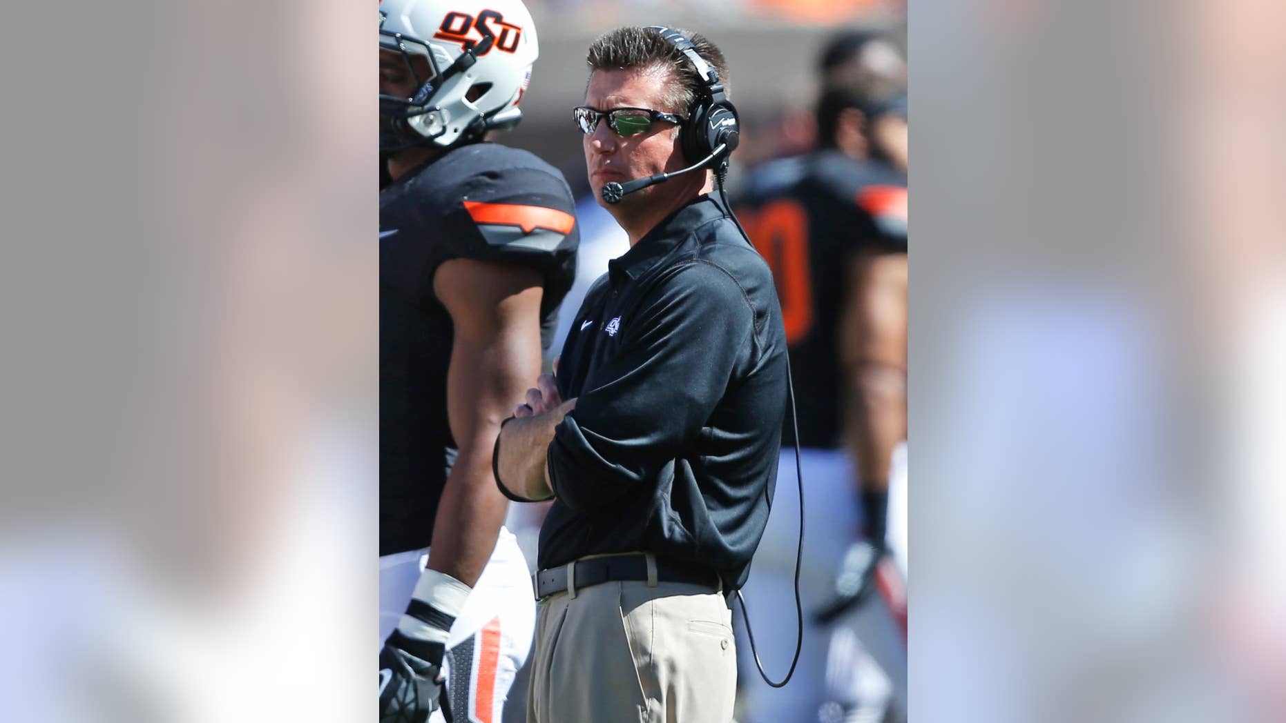 Oklahoma State head coach Mike Gundy watches from the sidelines in the fourth quarter of an NCAA college football game against Iowa State in Stillwater, Okla., Saturday, Oct. 4, 2014. Oklahoma State won 37-20. (AP Photo/Sue Ogrocki)