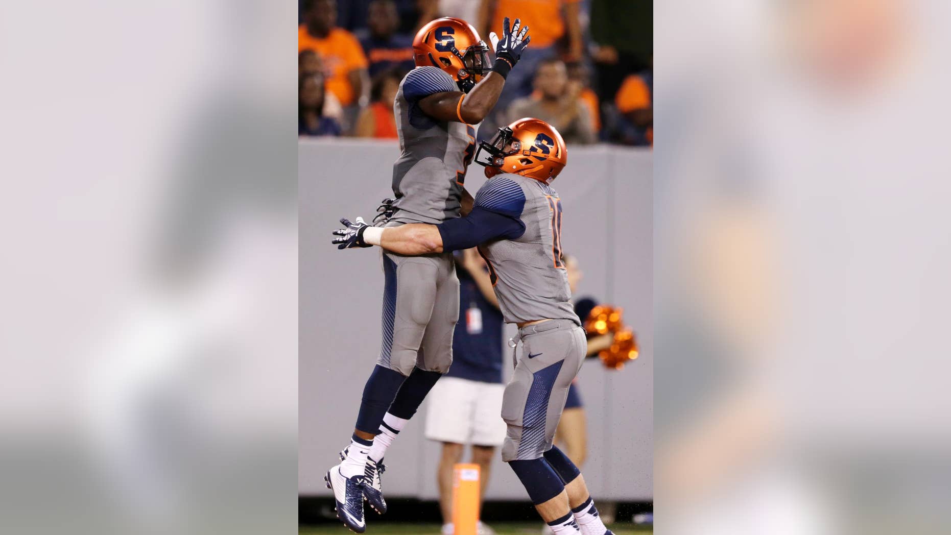Syracuse safety Durell Eskridge, left, is congratulated by Josh Kirkland after Eskridge scored on an interception during the second half of an NCAA college football game against Notre Dame, Saturday, Sept. 27, 2014, in East Rutherford, N.J. Notre Dame won 31-15. (AP Photo/Julio Cortez)
