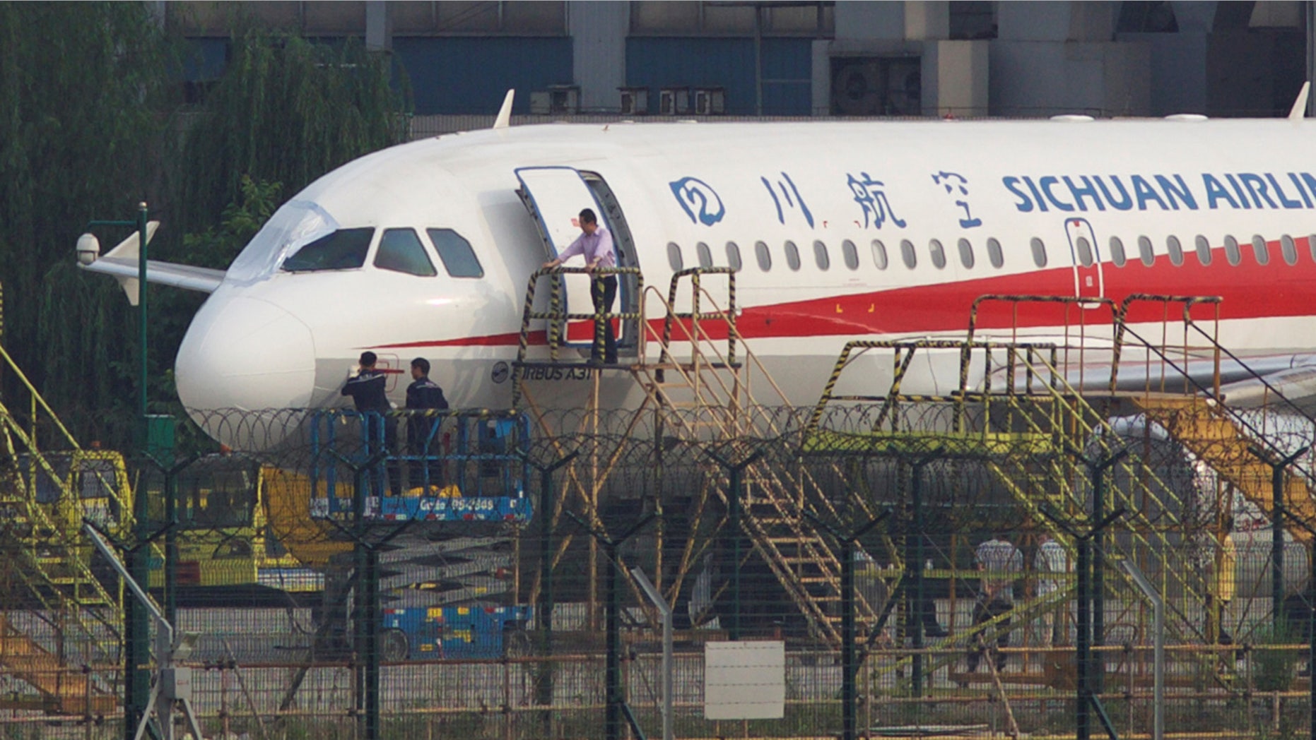 May 14: Workers inspect a Sichuan Airlines aircraft that made an emergency landing after a windshield on the cockpit broke off, at an airport in Chengdu, Sichuan province
