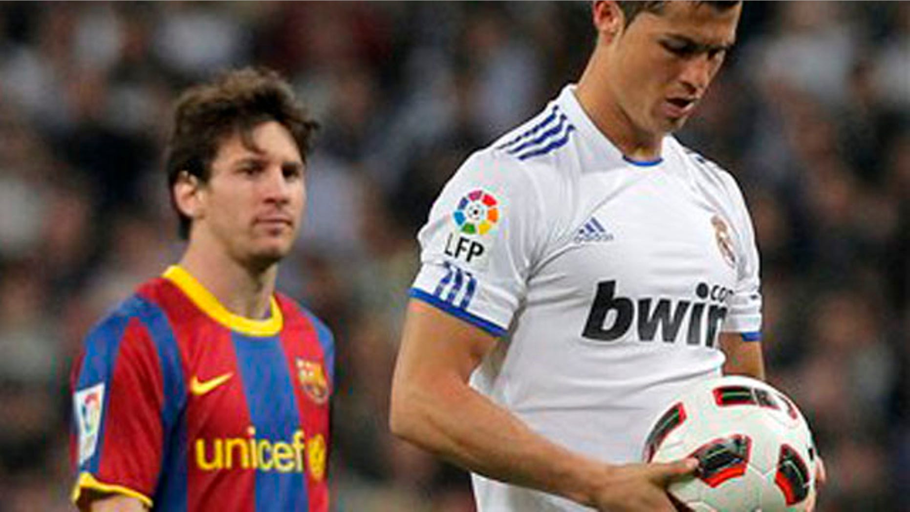 Real Madrid's Cristiano Ronaldo from Portugal, right, holds the ball besides Barcelona's Lionel Messi from Argentina, during their Spanish La Liga soccer match at the Santiago Bernabeu stadium in Madrid, Saturday, April 16, 2011. (AP Photo/Andres Kudacki)