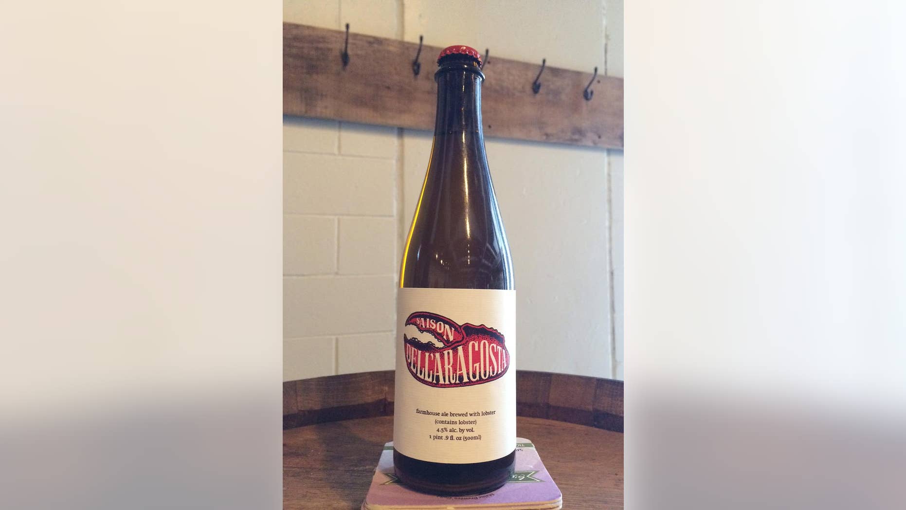 Maine-based Oxbow Brewing is offering a beer brewed with live lobsters and a dash of sea salt. It's a saison-style beer that the brewer hopes will capture two classic Maine summer flavors. (AP Photos/Patrick Whittle)
