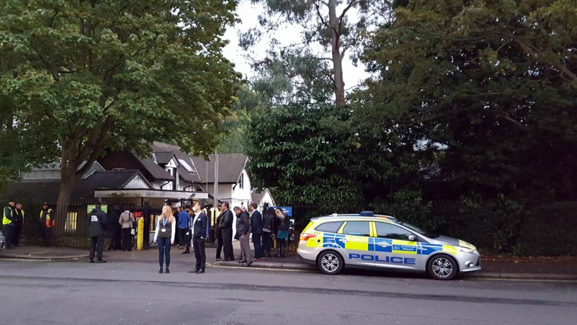 Police and evacuated visitors stand outside London Zoo after a gorilla escaped in London, Thursday, Oct. 13, 2016. London police say an incident involving a gorilla that escaped from its enclosure at the London Zoon has been concluded. There are reports the animal was subdued Thursday with a tranquilizer gun and recaptured. There were no initial reports of injuries. (Lynne Chapman via AP)