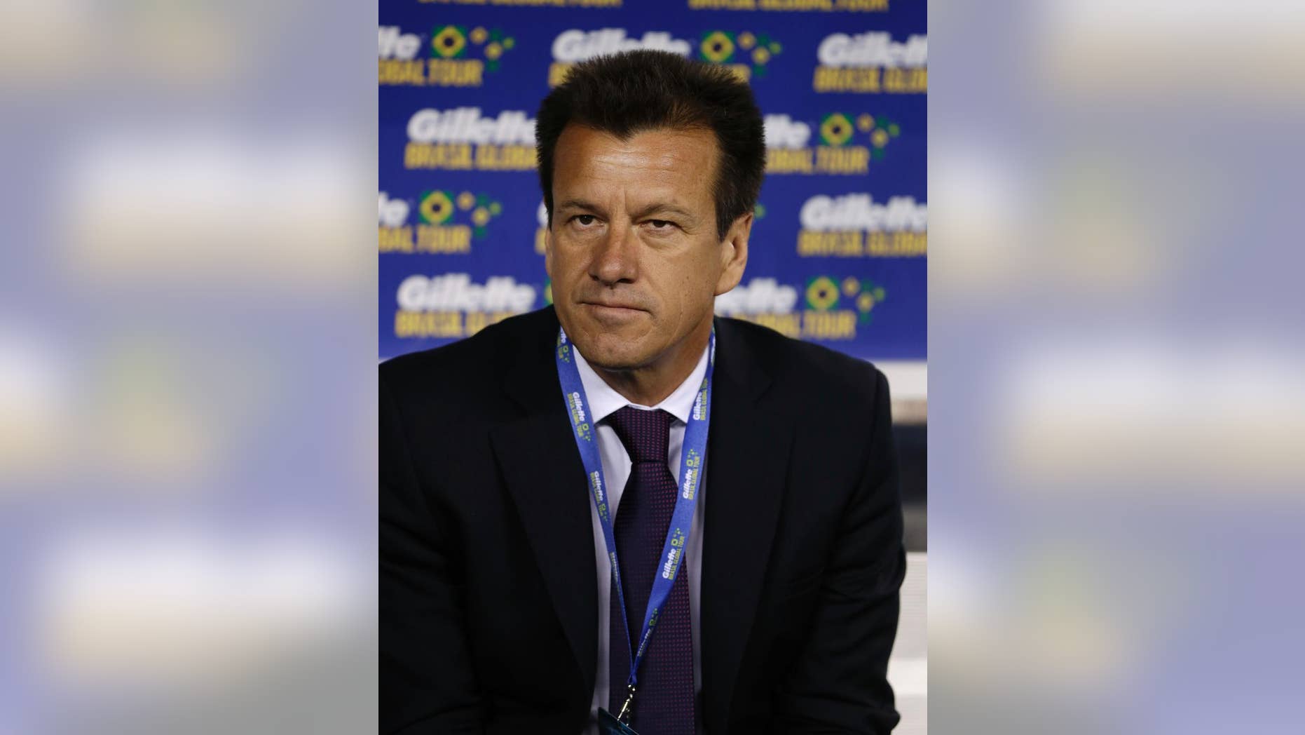 Brazil coach Dunga sits on the bench before an international soccer friendly between Ecuador and Brazil, Tuesday, Sept. 9, 2014, in East Rutherford, N.J. (AP Photo/Julio Cortez)