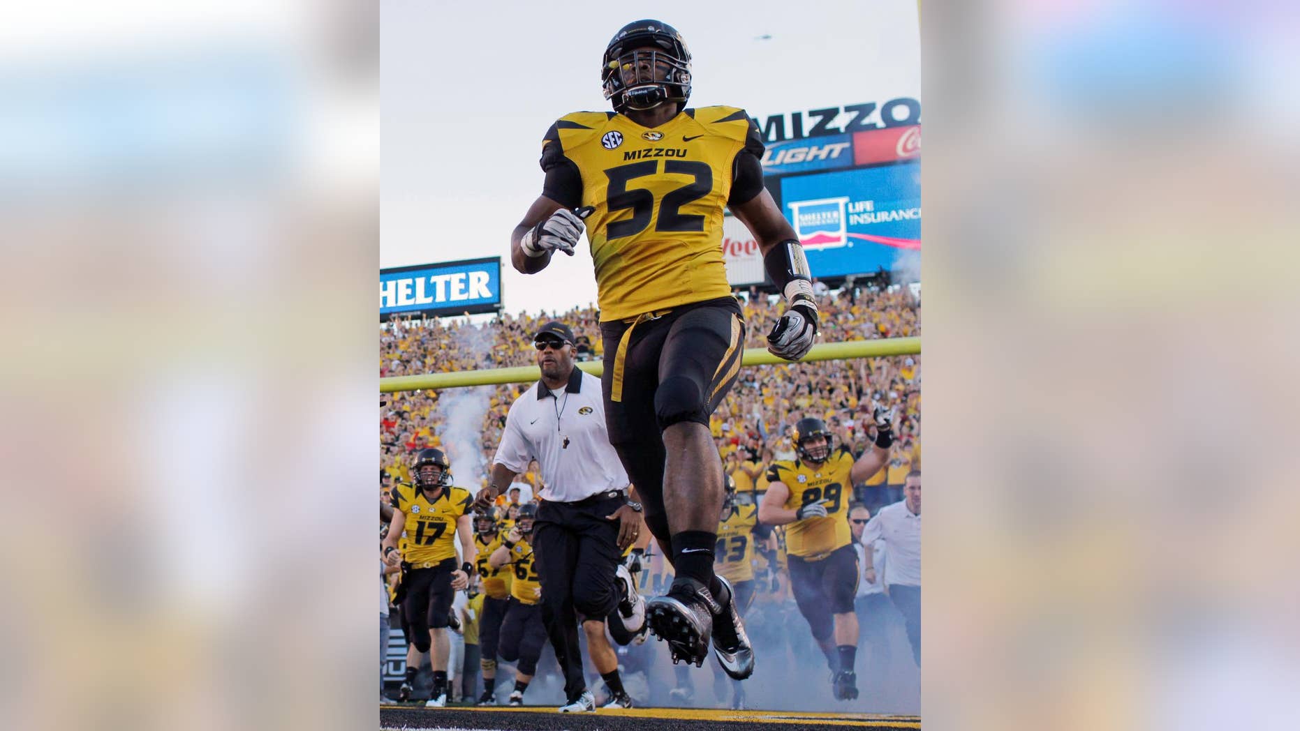 FILE - In this Sept. 8, 2012 file photo, Missouri's Michael Sam (52) runs onto the field along with their teammates before the start of an NCAA college football game against Georgia in Columbia, Mo. Sam was selected in the seventh round, 249th overall, by the St. Louis Rams in the NFL draft Saturday, May 10, 2014. The Southeastern Conference defensive player of the year last season for Missouri came out as gay in media interviews this year. (AP Photo/Jeff Roberson, File)