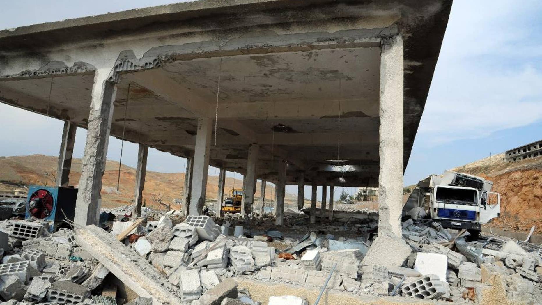 FILE - This Sunday, May 5, 2013 file photo released by the Syrian official news agency SANA shows a general view of damaged buildings wrecked by an Israeli airstrike, in Damascus, Syria. Israeli warplanes carried out two airstrikes Sunday near Damascus, one near the city's international airport and a second outside a town close to the Lebanese border, Syria's state news agency said. (AP Photo/SANA, File)