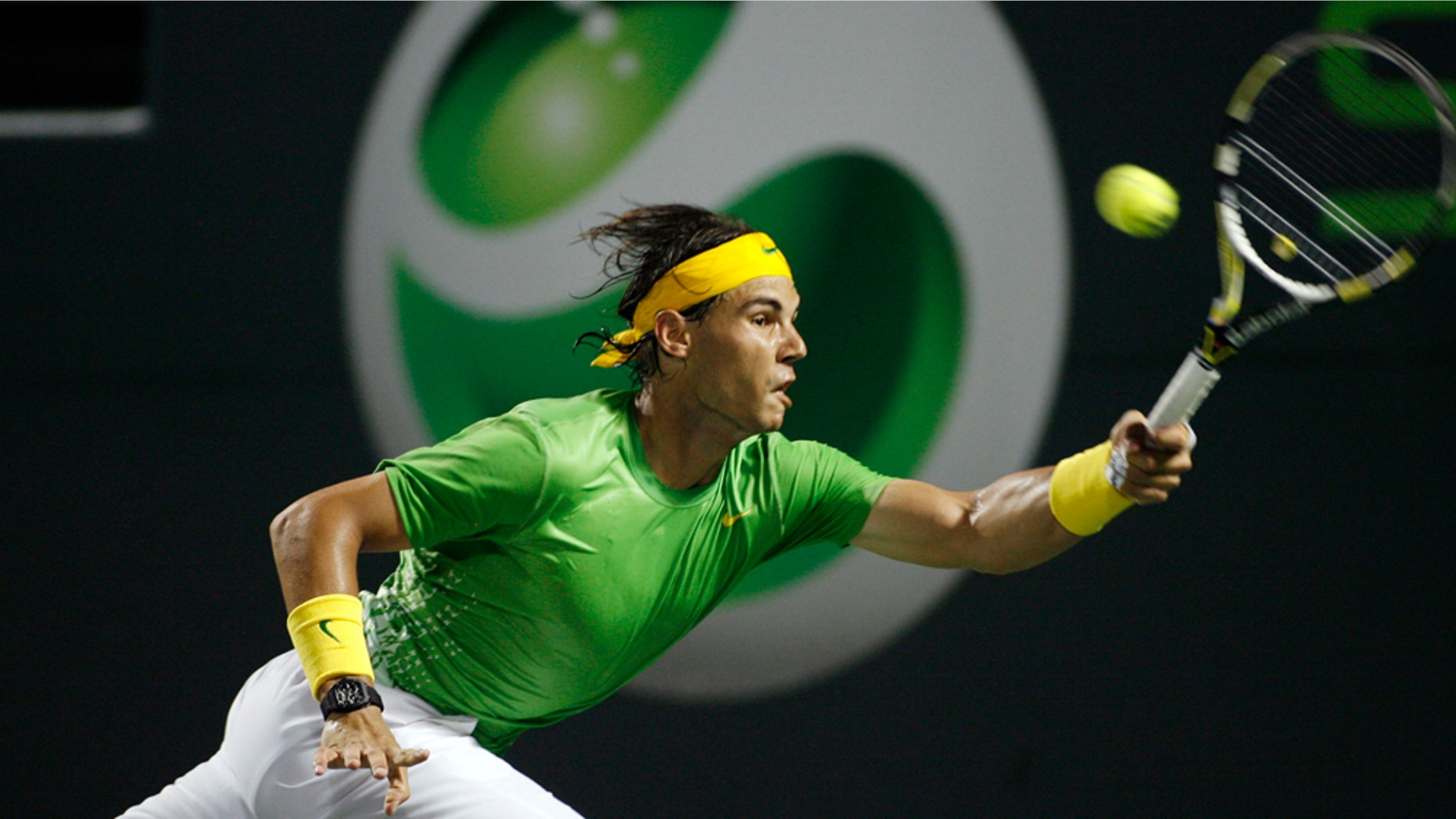 Rafael Nadal, of Spain, returns a serve from Roger Federer, of Switzerland, during semifinals action at the Sony Ericsson Open tennis tournament in Key Biscayne, Fla., Friday, April 1, 2011. (AP Photo/Jeffrey M. Boan)