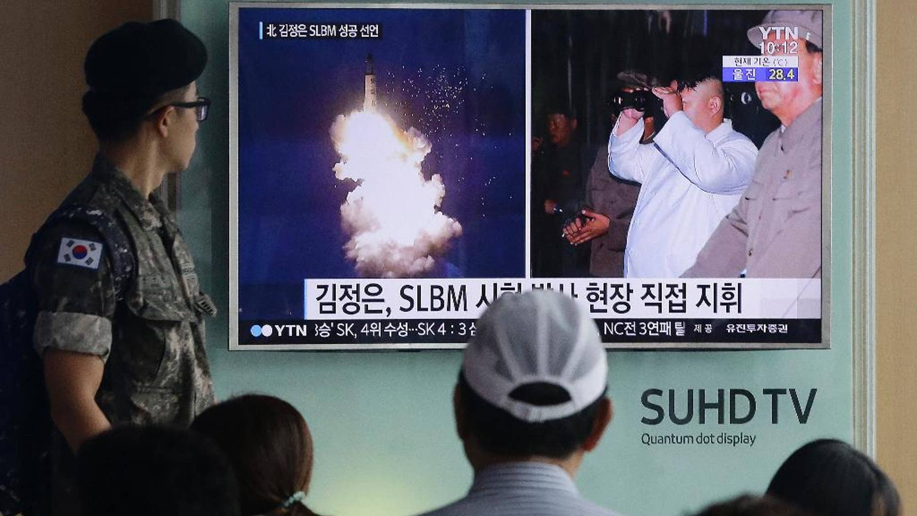 FILE - In this Thursday, Aug. 25, 2016, file photo, a South Korean army soldier watches a TV news program showing images published in North Korea's Rodong Sinmun newspaper of North Korea's ballistic missile believed to have been launched from underwater and North Korean leader Kim Jong-un, at Seoul Railway station in Seoul, South Korea. The UN Security Council is strongly condemning four North Korean ballistic missile launches in July and August, calling them "grave violations" of a ban on all ballistic missile activity. A press statement approved by all 15 members Friday night deplored the fact that the North's ballistic missile activities are contributing to its development of nuclear weapon delivery systems and increasing tensions. (AP Photo/Ahn Young-joon, File)