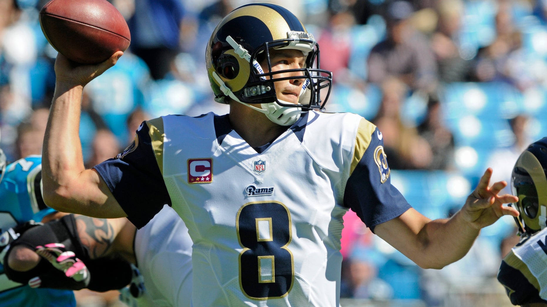 St. Louis Rams quarterback Sam Bradford (8) looks to pass against the Carolina Panthers in the first half of an NFL football game in Charlotte, N.C., Sunday, Oct. 20, 2013. (AP Photo/Mike McCarn)