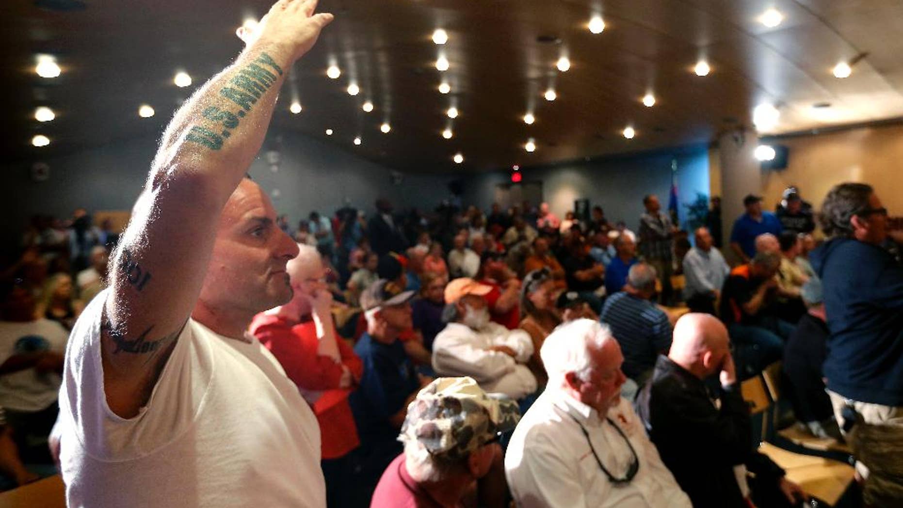 Veteran Mark Howey waits to ask a question as Sen. John McCain speaks during a forum with veterans on Friday, May 9, 2014, in Phoenix. McCain was discussing lapses in care at the Phoenix Veterans Affairs hospital that prompted a national review of operations around the country. (AP Photo/Matt York)