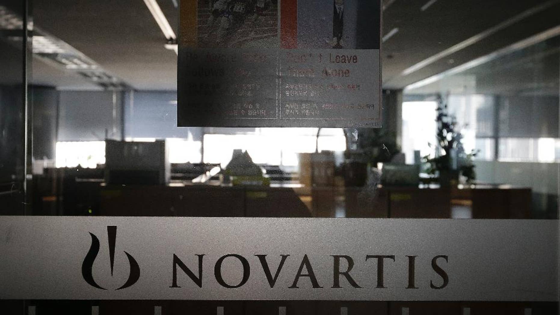A logo of Swiss pharmaceutical company Novartis is seen at the Novartis Korea office in Seoul, South Korea, Saturday, Aug. 13, 2016. Prosecutors indicted the former chief executive of the South Korean unit of Novartis and five other former and current managers over allegations they illegally paid doctors 2.6 billion won ($2.3 million) in return for prescribing the company's drugs. (AP Photo/Ahn Young-joon)