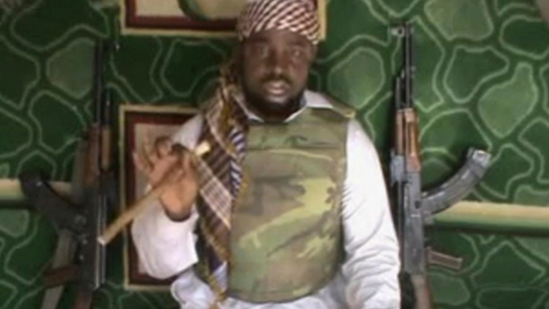 FILE: This file image made available from Wednesday, Jan. 10, 2012, taken from video posted by Boko Haram sympathizers shows the leader of the radical Islamist sect Imam Abubakar Shekau. The leader of an Islamic uprising in northeastern Nigeria boasts in a new video of a daring attack on military bases in a provincial capital and threatens to attack the United States next, it has been reported on Thursday, Dec. 12, 2013. Few believe the Boko Haram terrorist network has such capability though there are fears its insurgency could spread to neighboring states. In his first statement since Washington designated Boko Haram a terrorist network last month, Abubakar Shekau swore at the United States, calling it a prostitute nation of infidels and liars. The United States in July posted a reward of $7 million for information leading to Shekau’s arrest. (AP Photo, File ) THE ASSOCIATED PRESS CANNOT INDEPENDENTLY VERIFY THE CONTENT, DATE, LOCATION OR AUTHENTICITY OF THIS MATERIAL