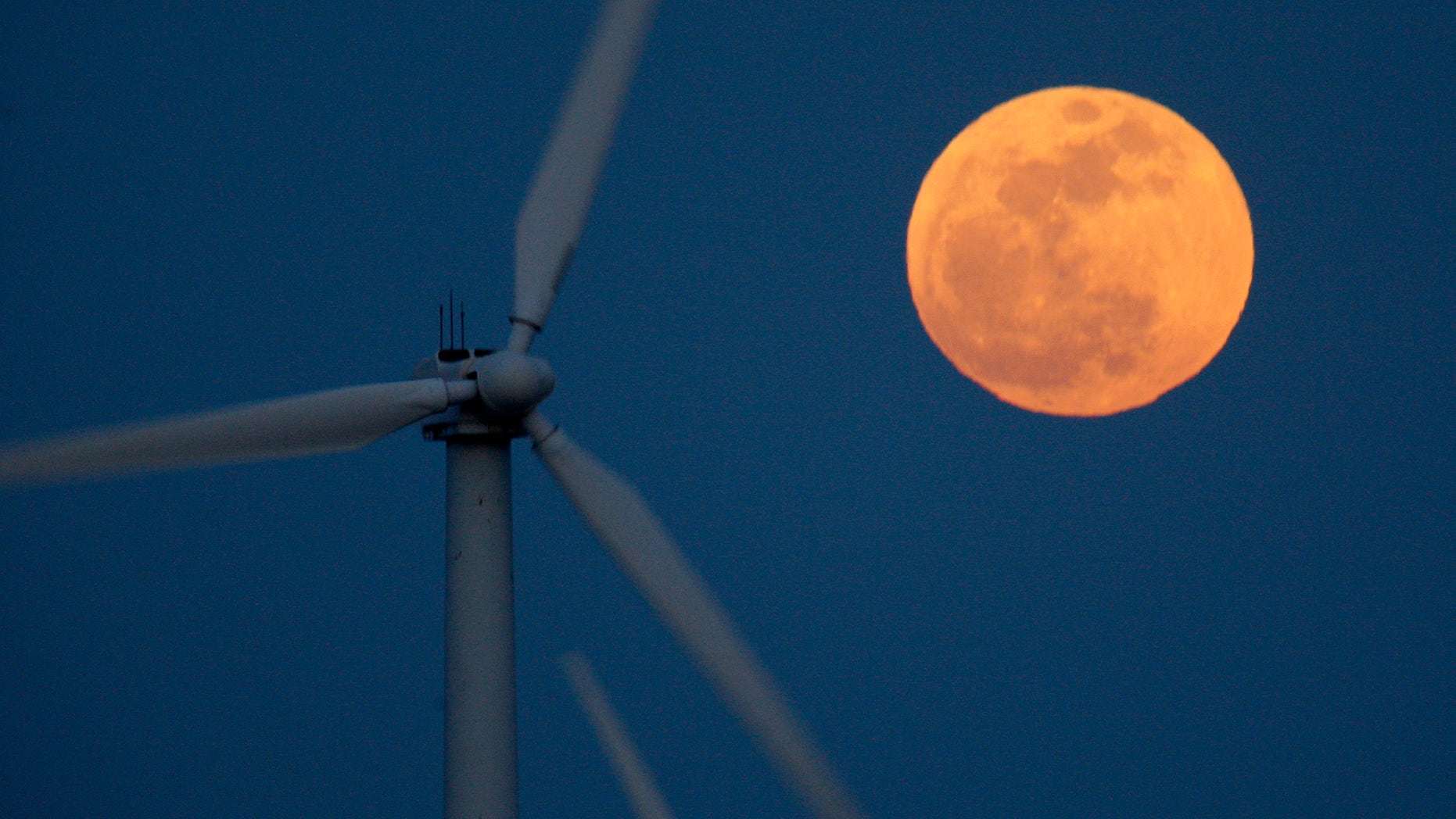 PALM SPRINGS, CA - MAY 5: A perigee moon, or supermoon, rises behind wind turbines on May 5, 2012 near Palm Springs, California. The moon appears especially big and bright during this once-a-year cosmic event as the full moon is at its closest to the Earth in its elliptical orbit. The perigee side of its orbit is about 31,000 miles closer than the opposite, or apogee, side. The bright light of the full moon also hides all but the brightest meteors of the Eta Aquarid meteor shower, the remnant debris trail of Halley's Comet. (Photo by David McNew/Getty Images)