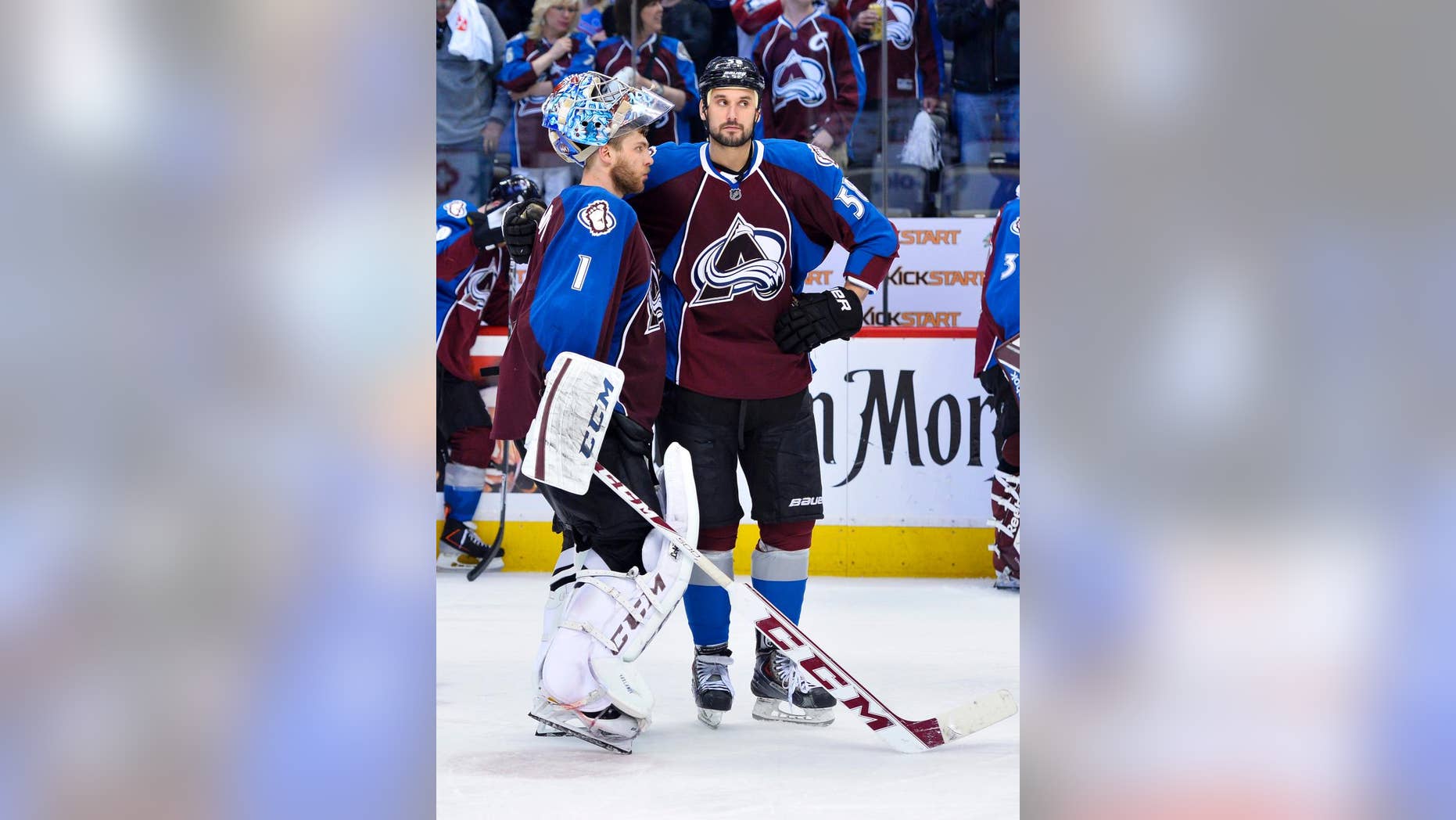 Colorado Avalanche goalie Semyon Varlamov (1) of Russia and Patrick Bordeleau (58) stand following the team's 5-4 overtime loss to the Minnesota Wild following Game 7 of an NHL hockey first-round playoff series on Wednesday, April 30, 2014, in Denver. Minnesota won 5-4 to win the series. (AP Photo/Jack Dempsey)
