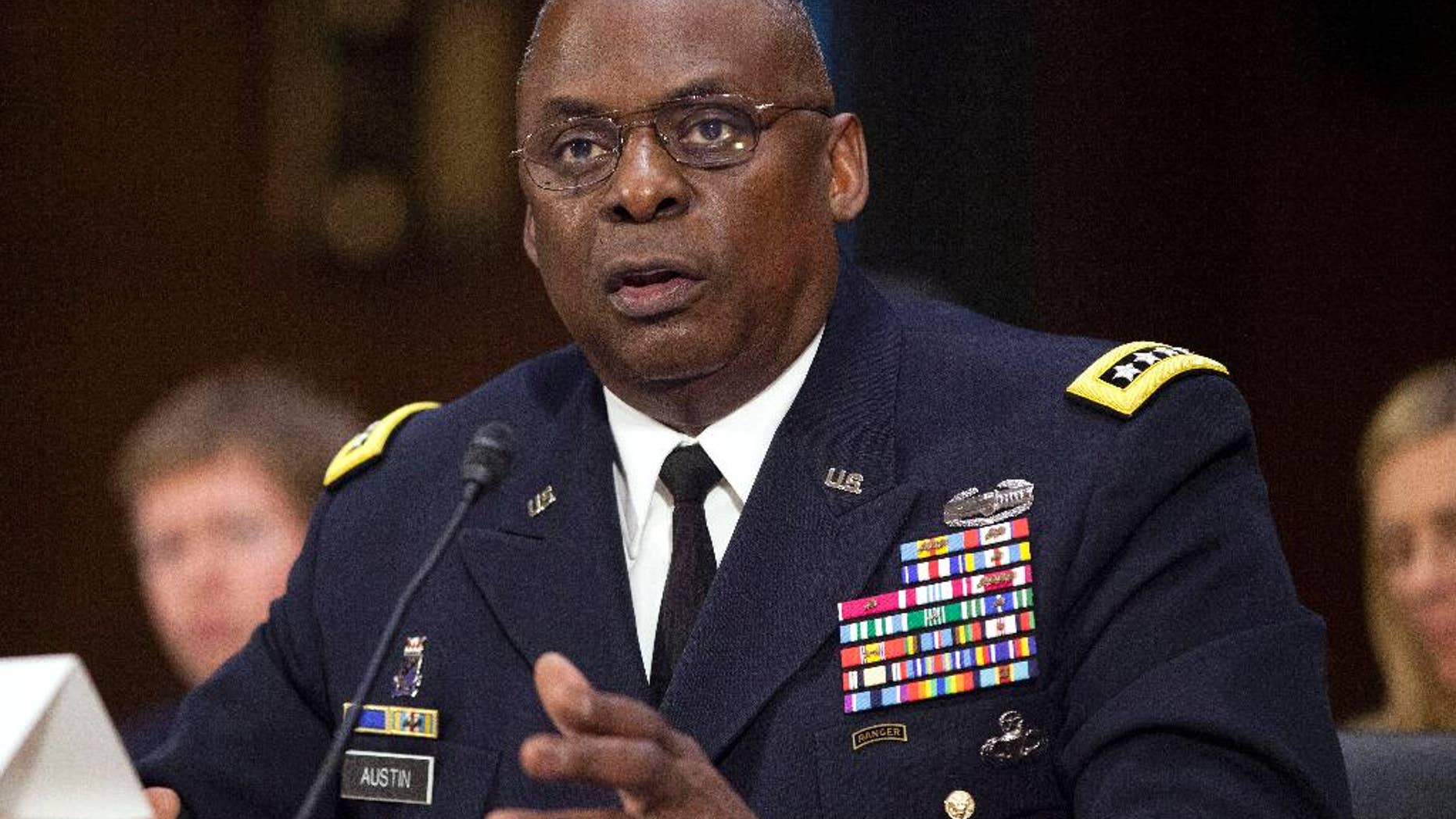 In this Sept. 16, 2015, photo, U.S. Central Command Commander Gen. Lloyd Austin III, testifies on Capitol Hill in Washington. The Obama administration is preparing a major overhaul of its failed effort to train thousands of moderate Syrian rebels to fight the Islamic State group, shifting from preparing rebels for frontline combat to a plan to embed them with established Kurdish and Arab forces in northeastern Syria, U.S. officials said. The discussion of a new approach comes a day after Austin, told Congress that the $500 million effort to train 5,000 moderate Syrian rebels in a year had yielded "four or five" new fighters after another 50 or so were captured, wounded or fled in their first encounter with extremist militants. (AP Photo/Pablo Martinez Monsivais)