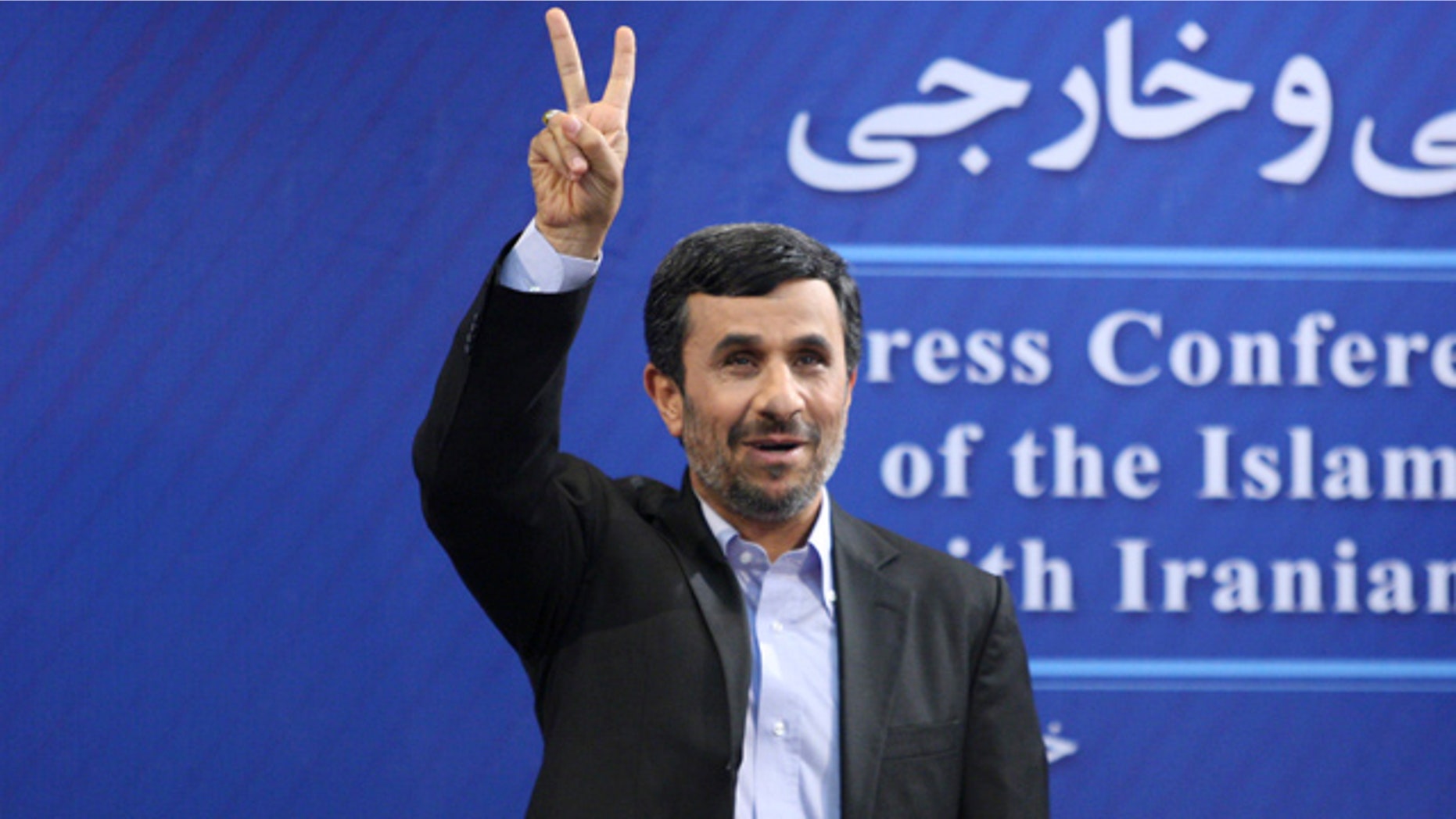June 7: Iranian President Mahmoud Ahmadinejad flashes a victory sign as he arrives for his press conference in Tehran, Iran.
