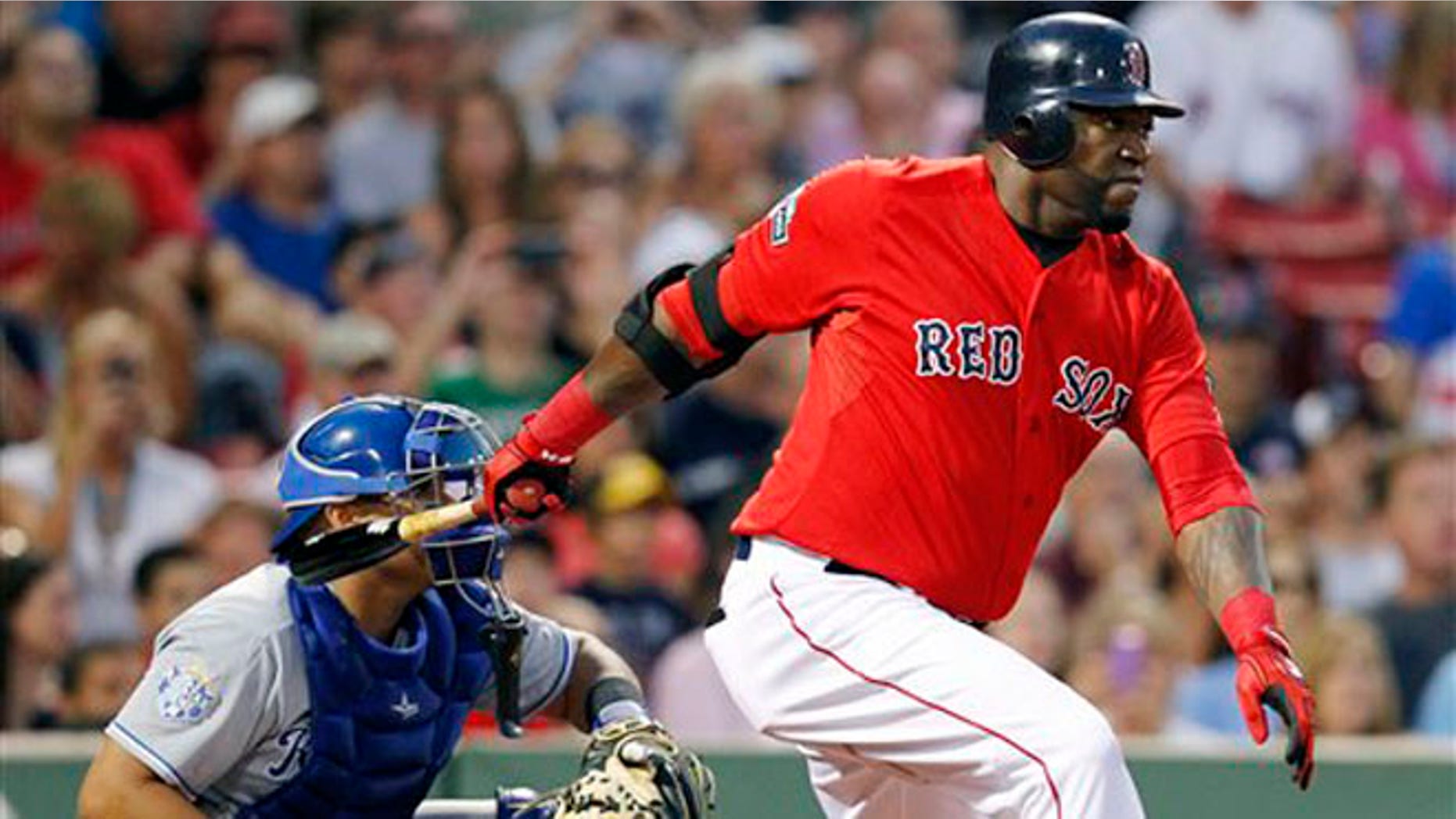 Boston Red Sox's David Ortiz, right, follows through on a two-run single in front of Kansas City Royals' Brayan Pena in the first inning of a baseball game in Boston, Friday, Aug. 24, 2012. (AP Photo/Michael Dwyer)